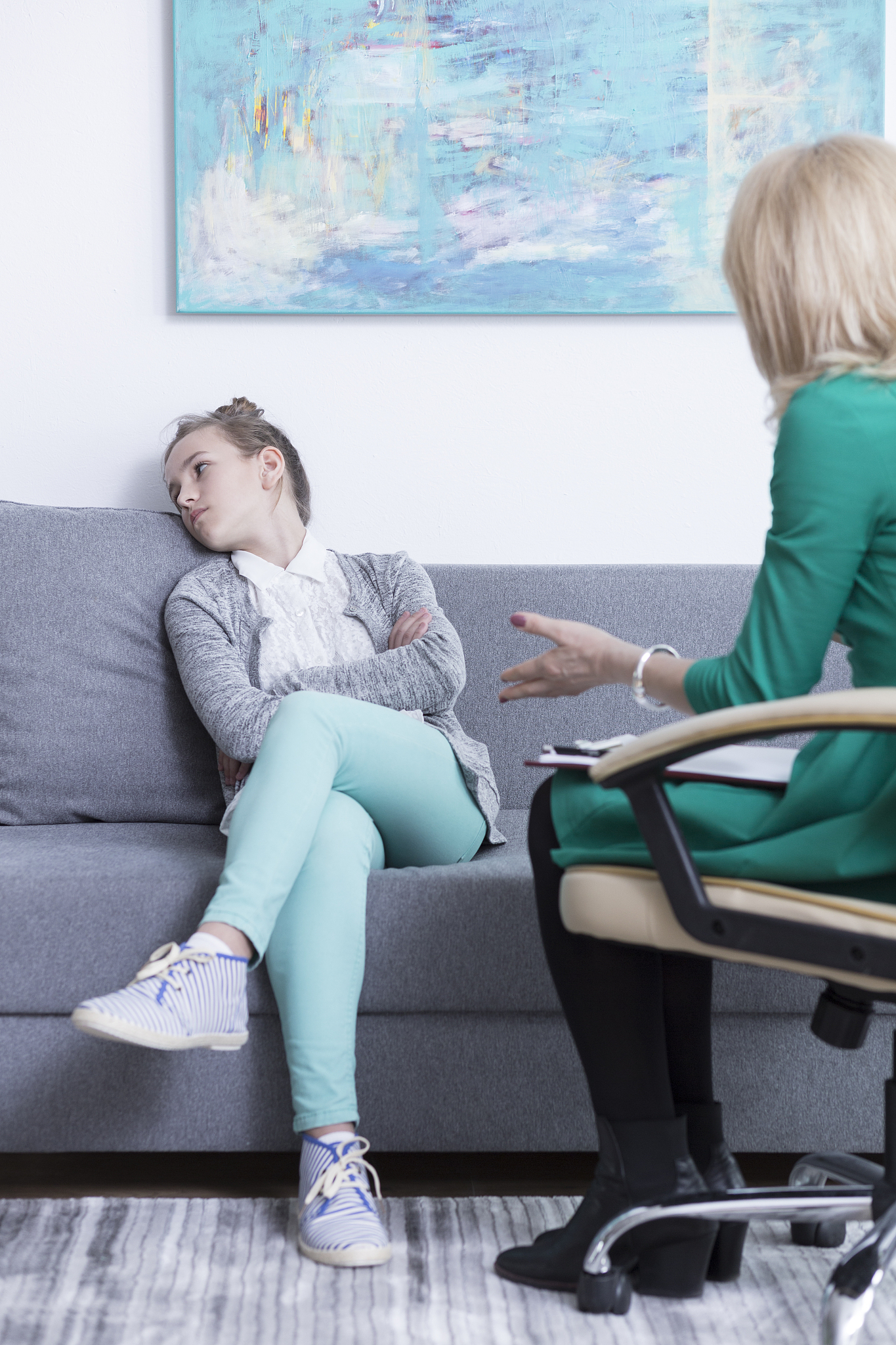upset teenage girl at psychologist