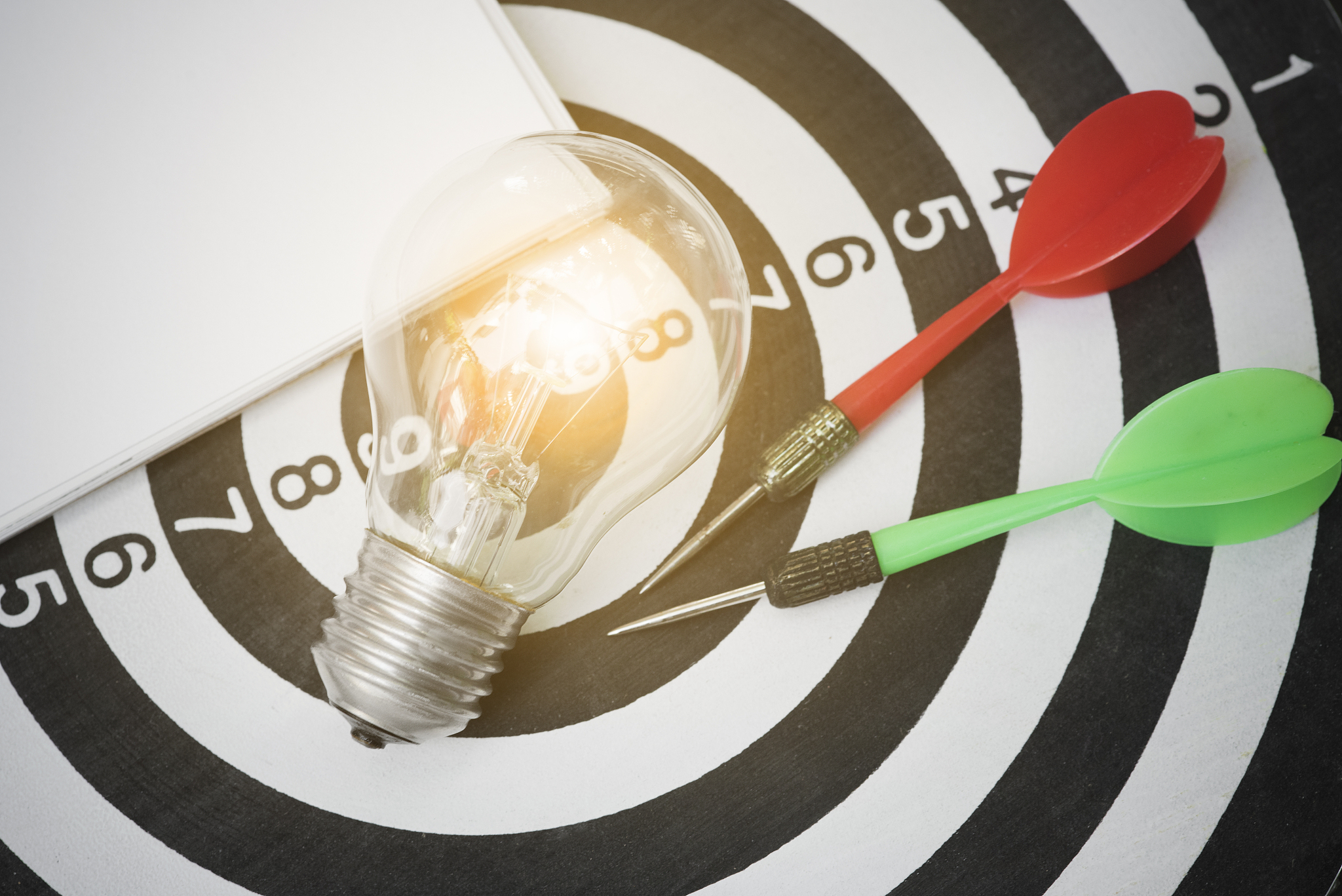 lightbulb on dartboard with arrow. concept goal for new ideas wi