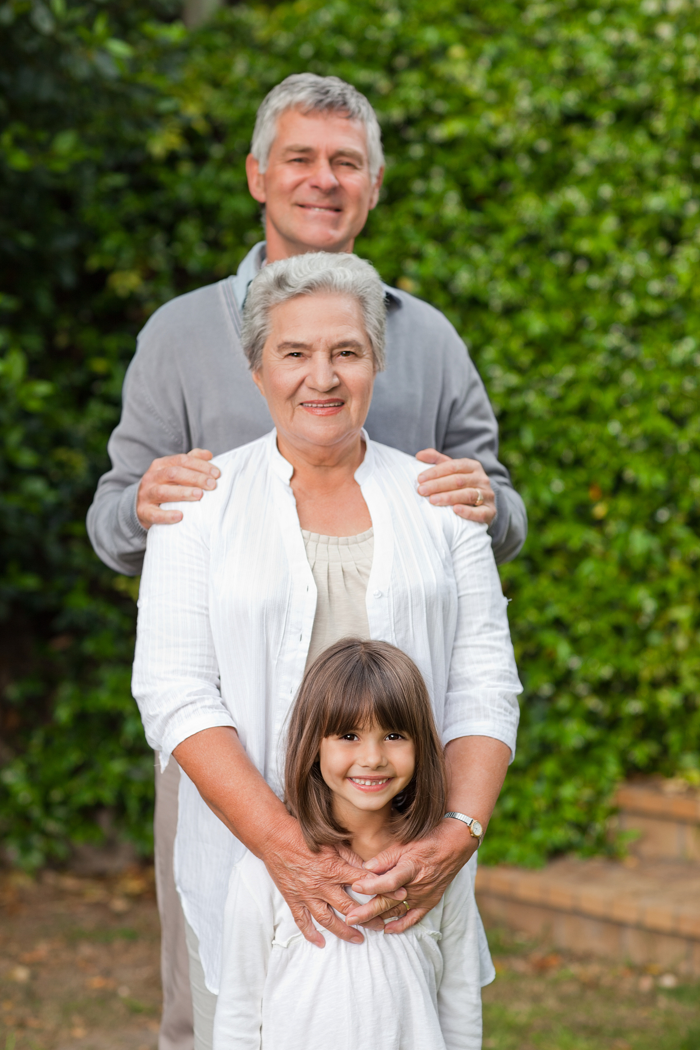 smiling family looking at the camera in the garden