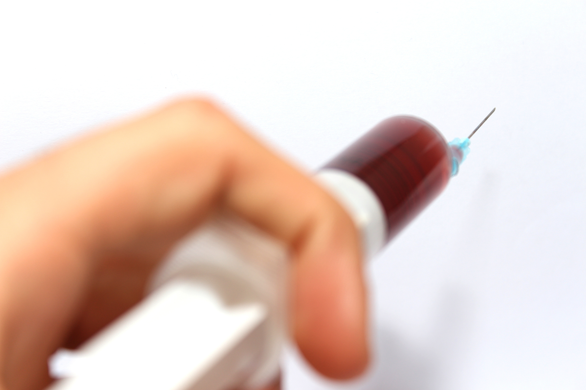 extracted blood in syringe with hypodermic needle