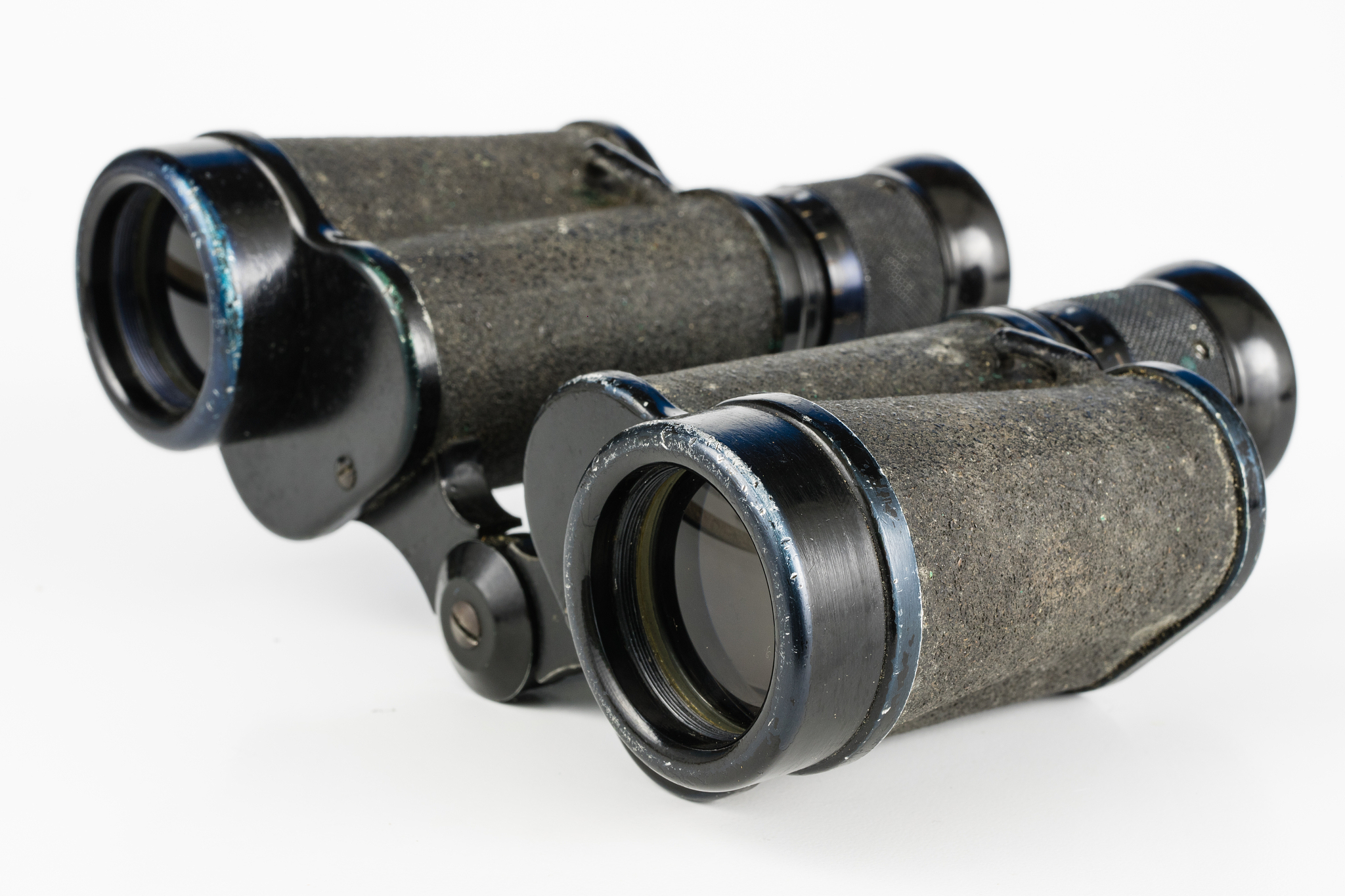 old metal binoculars on a white table. old military accessories 