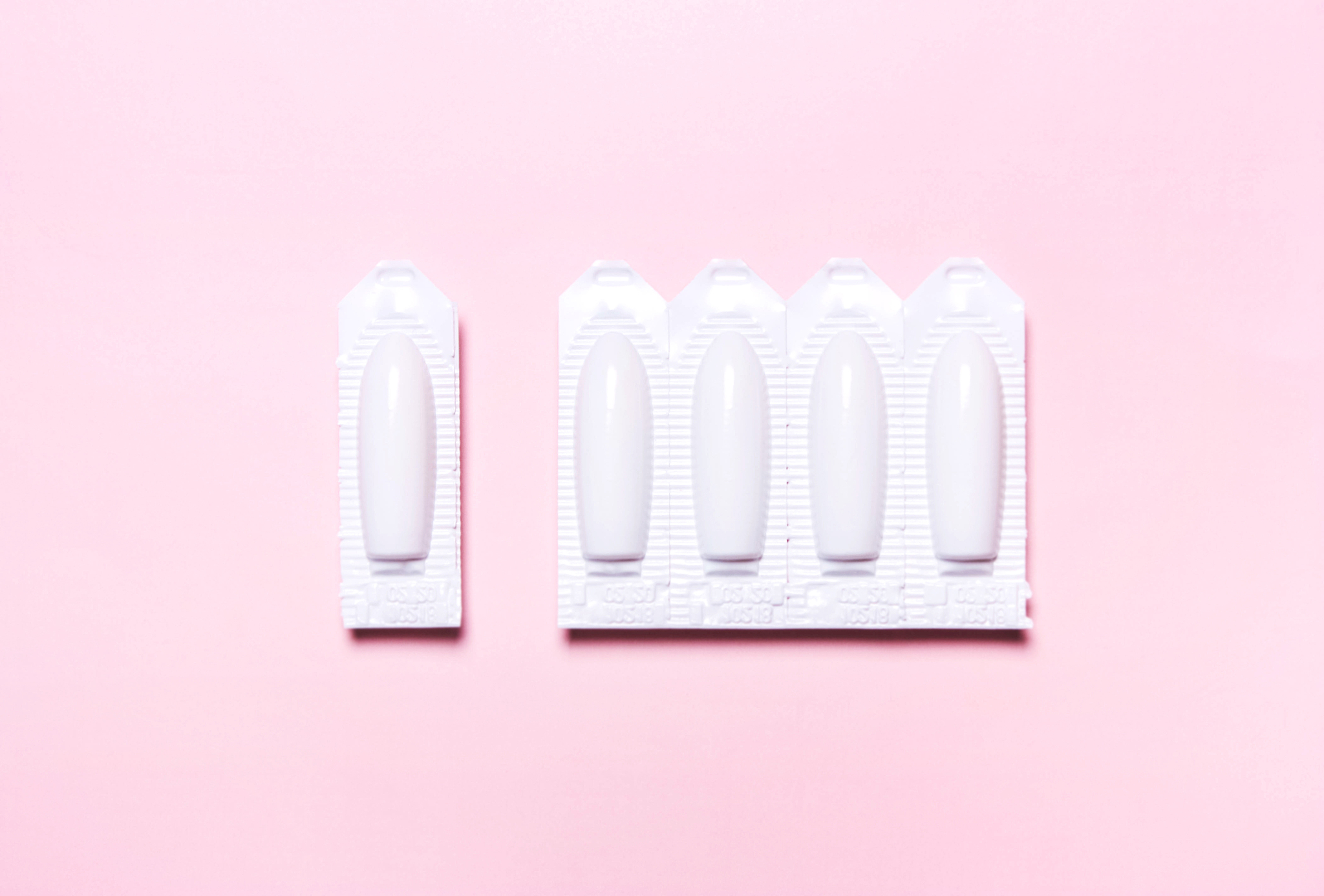 medical, vaginal suppository on a pink background, for the treat