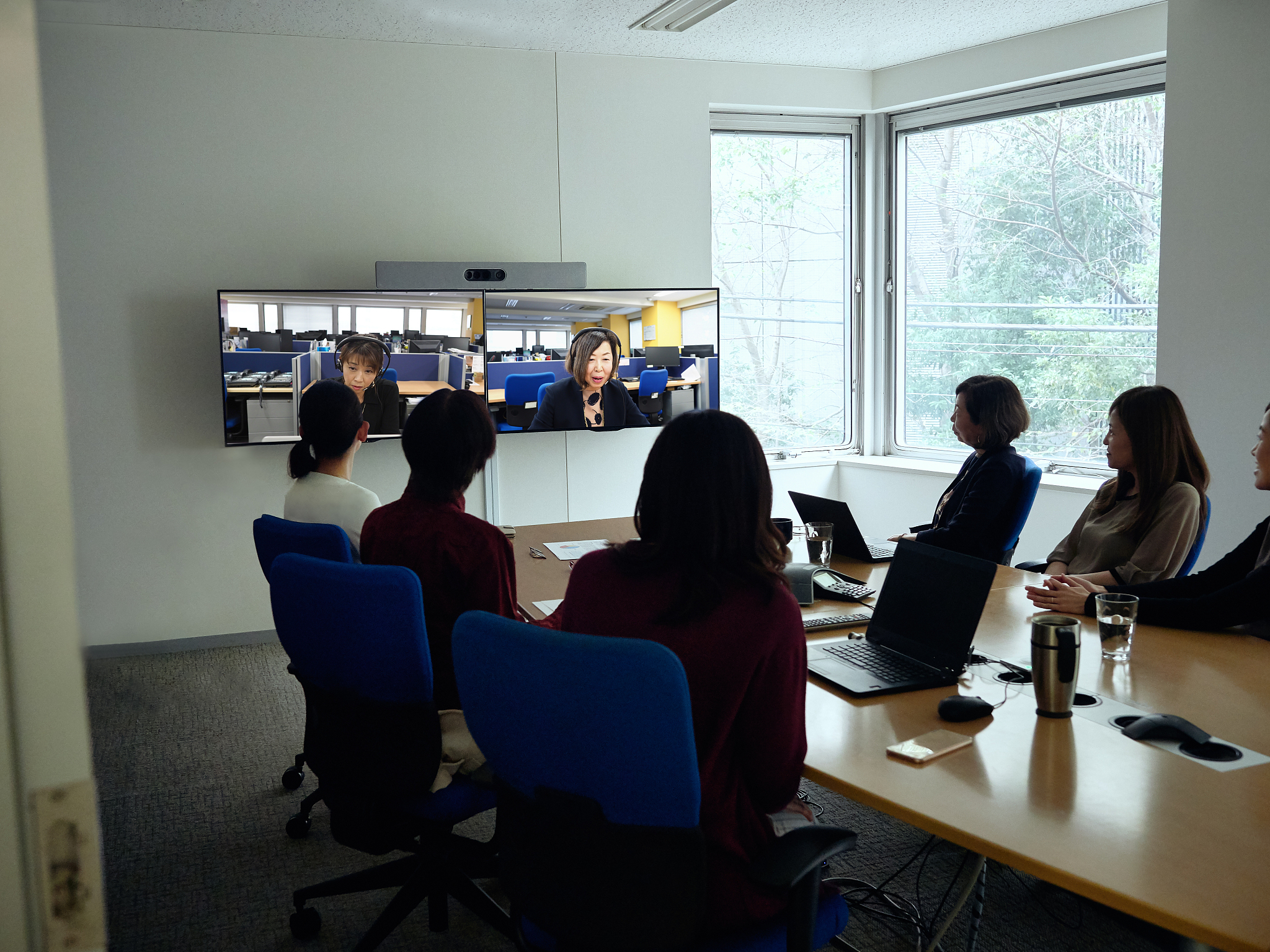 coworkers participating in video conference call.