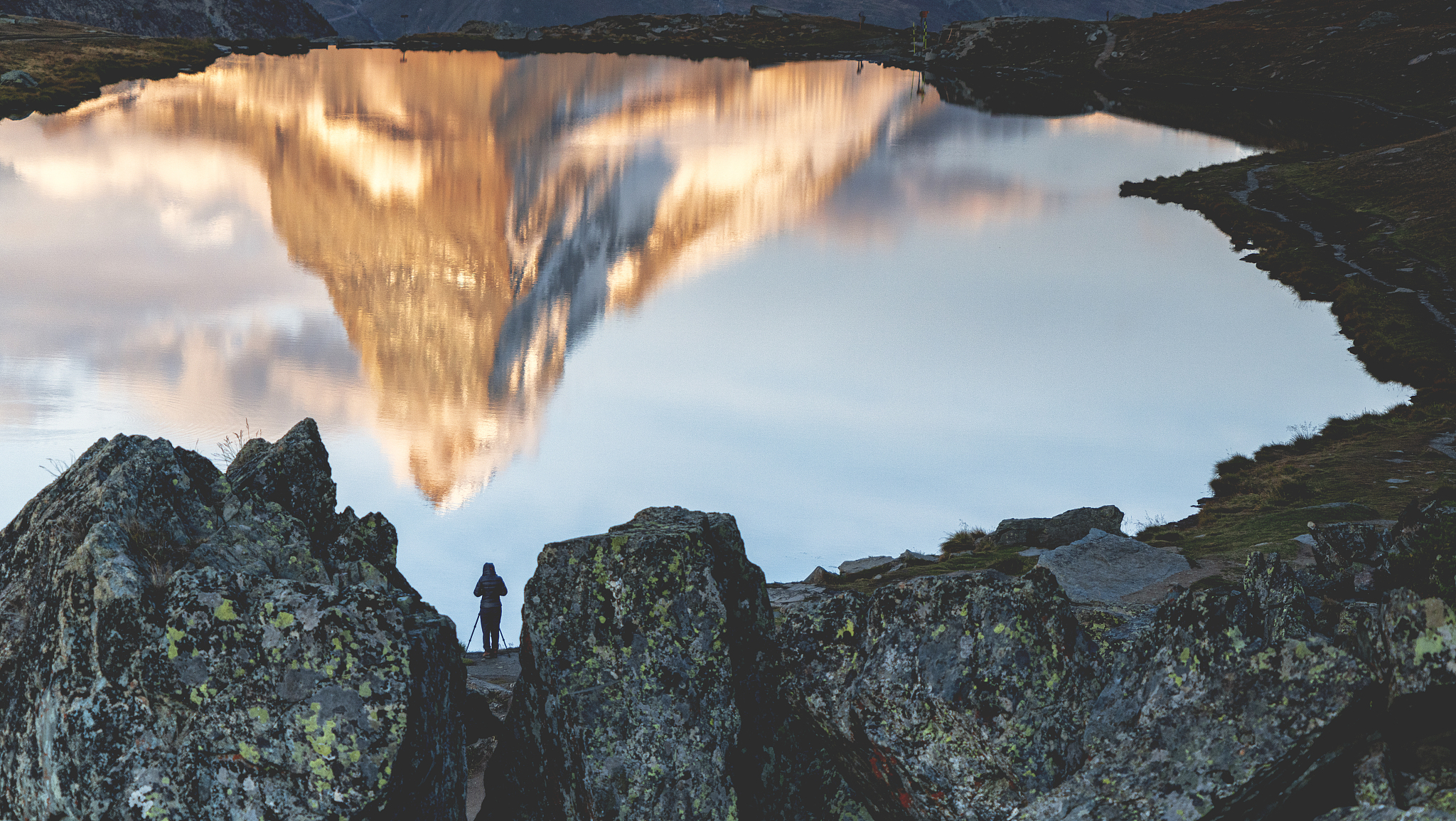 man photographing matterhorn reflected in stellisee lake