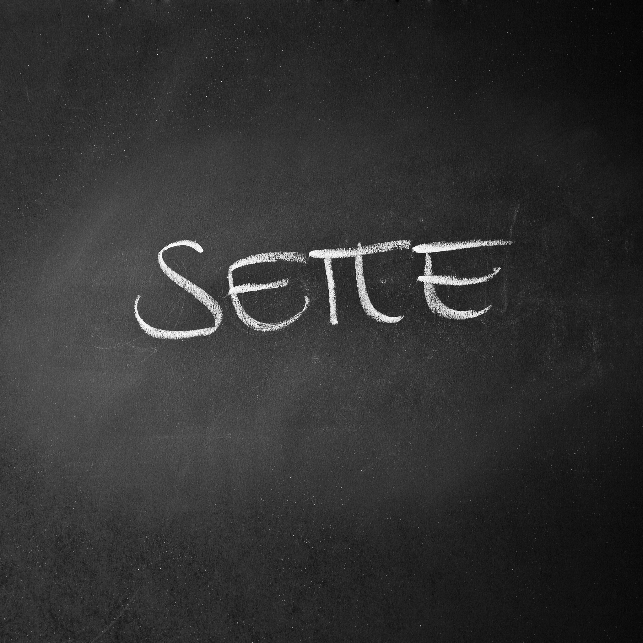 glyph of the italian number seven written on a blackboard