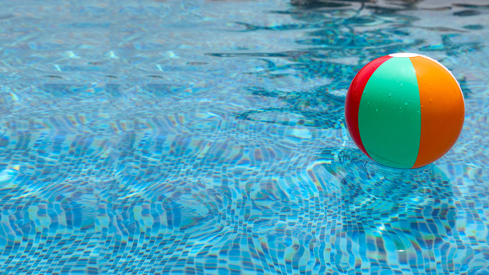 beach ball in pool. colorful inflatable ball floating in swimmin