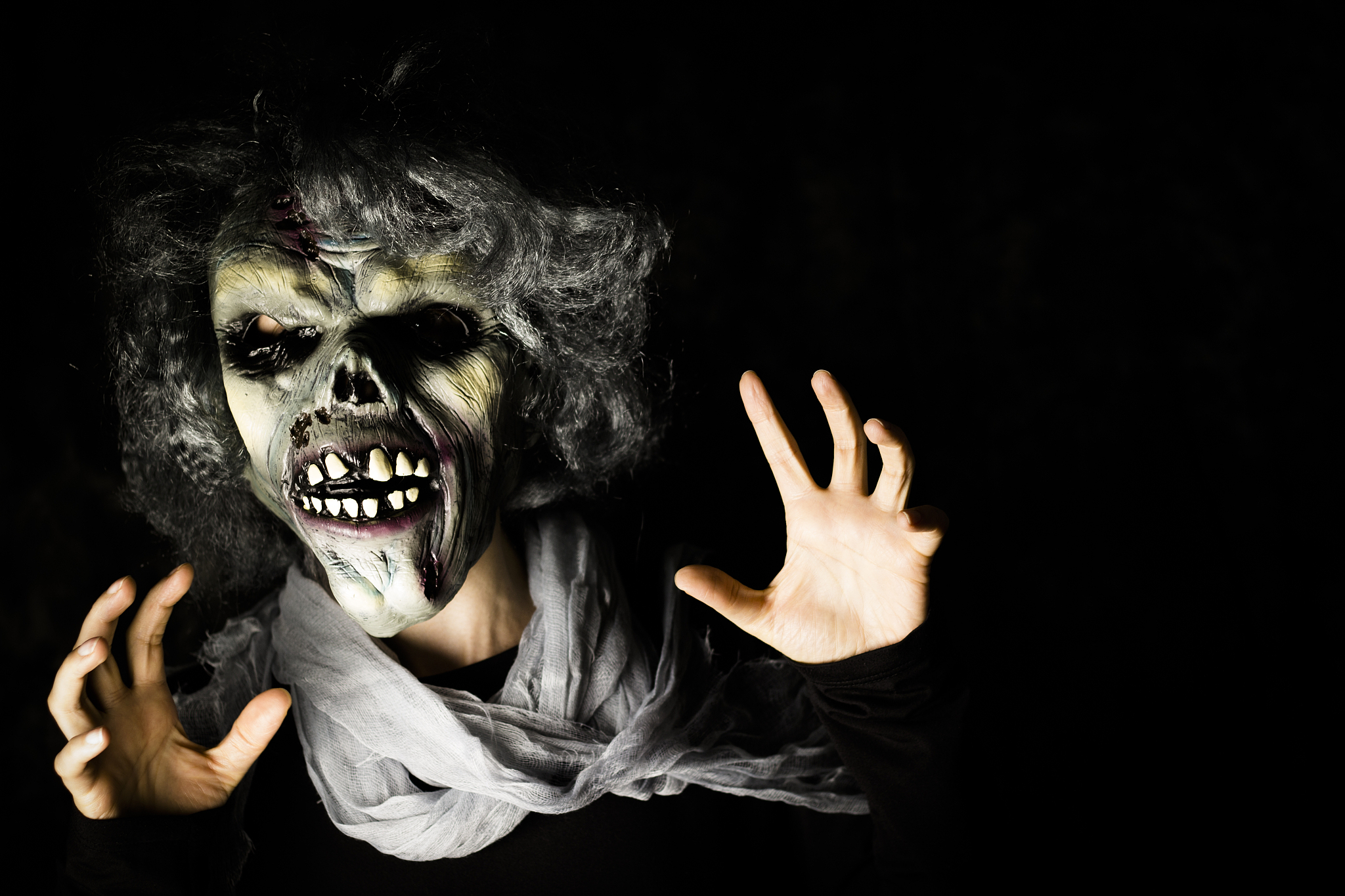 portrait of person in evil mask in darkroom