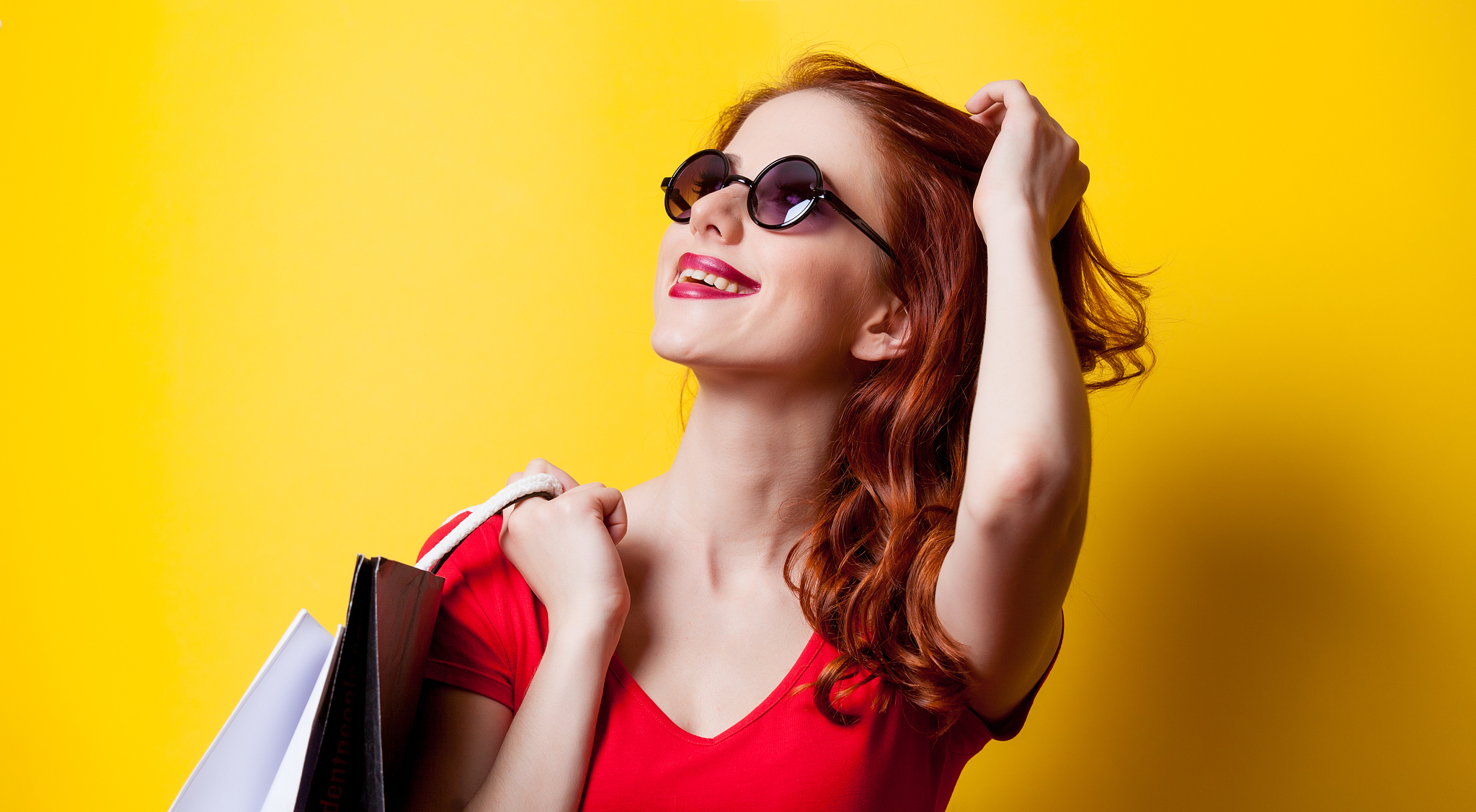 redhead woman with shopping bags