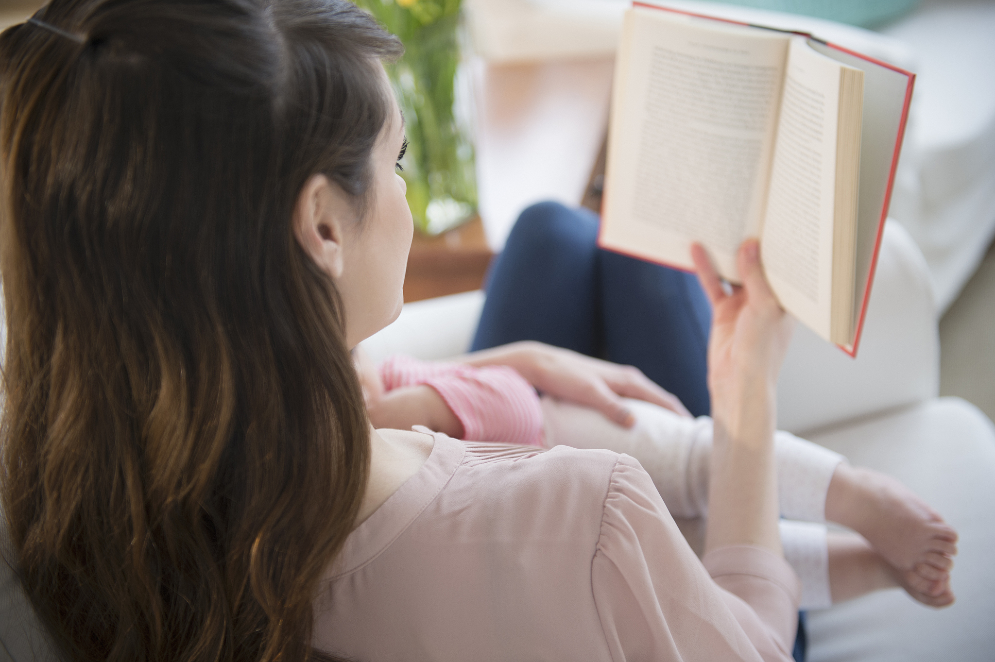 usa, new jersey, jersey city, young woman reading book and holdi