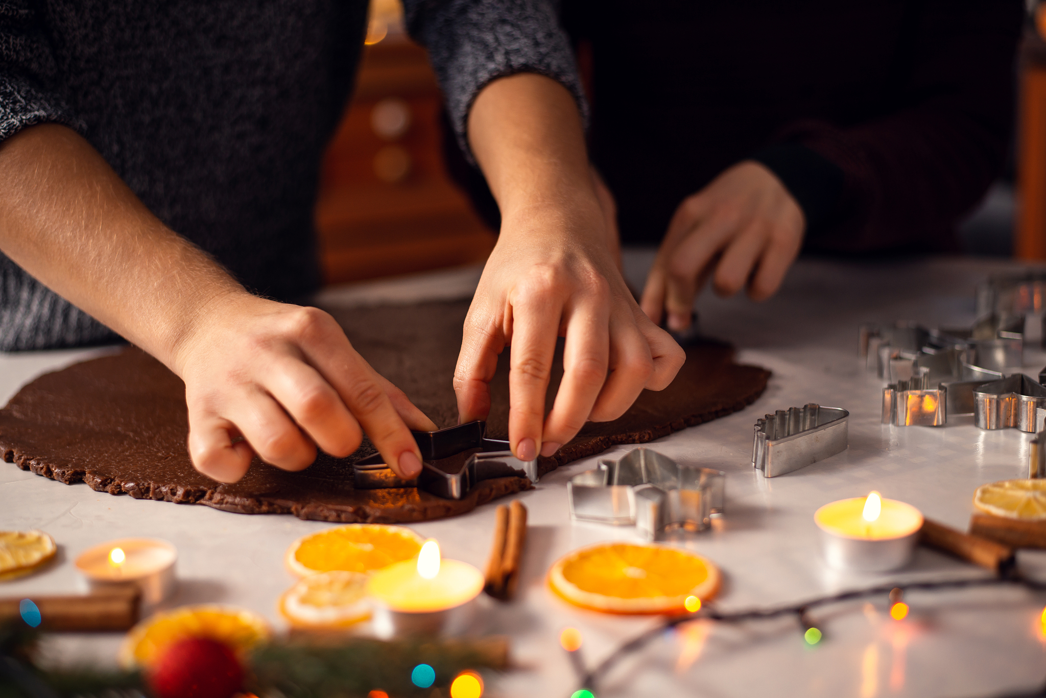 mother showing her son how to make cookies.