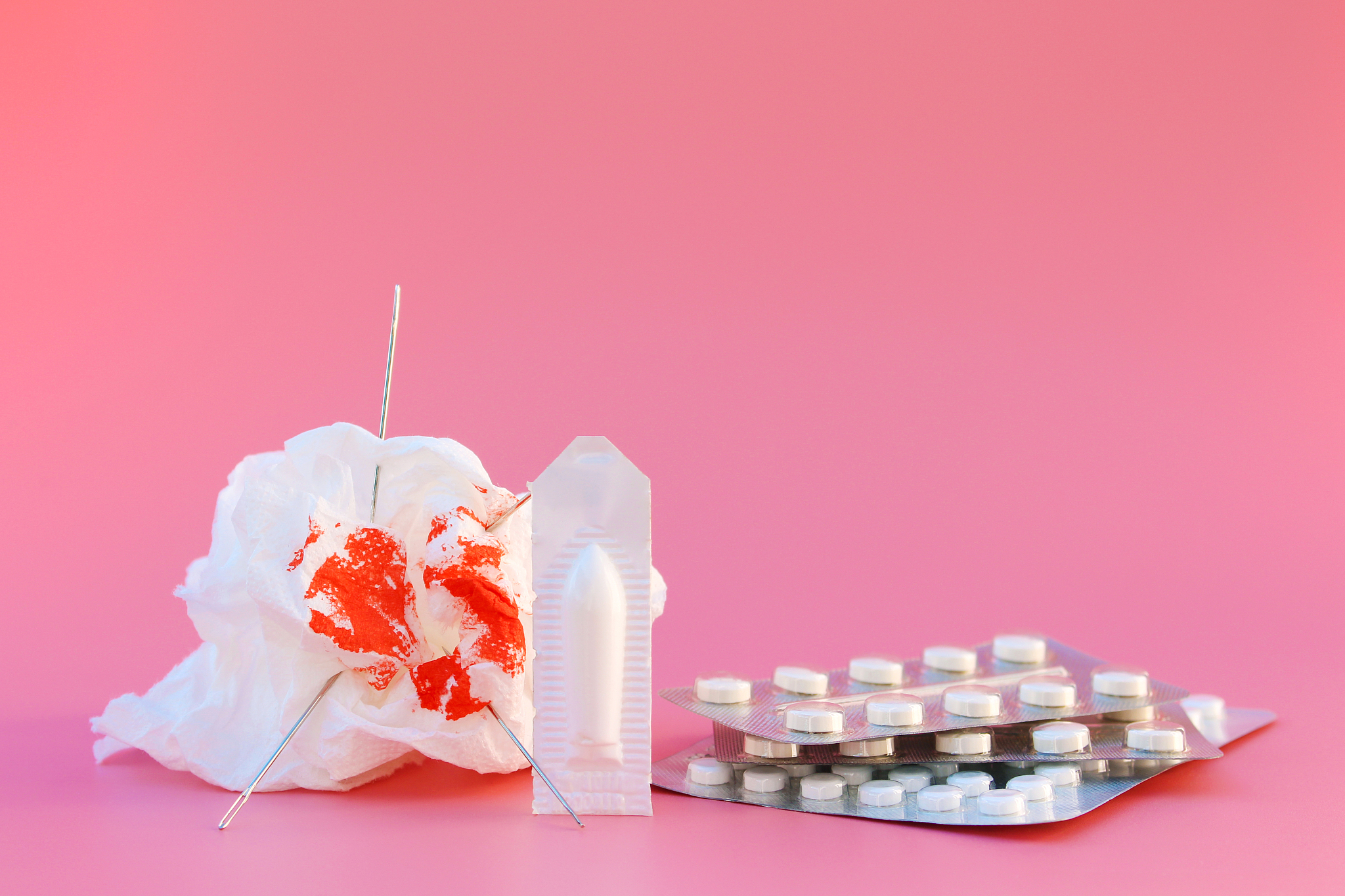 toilet paper with blood, pills, candle. concept of hemorrhoid tr