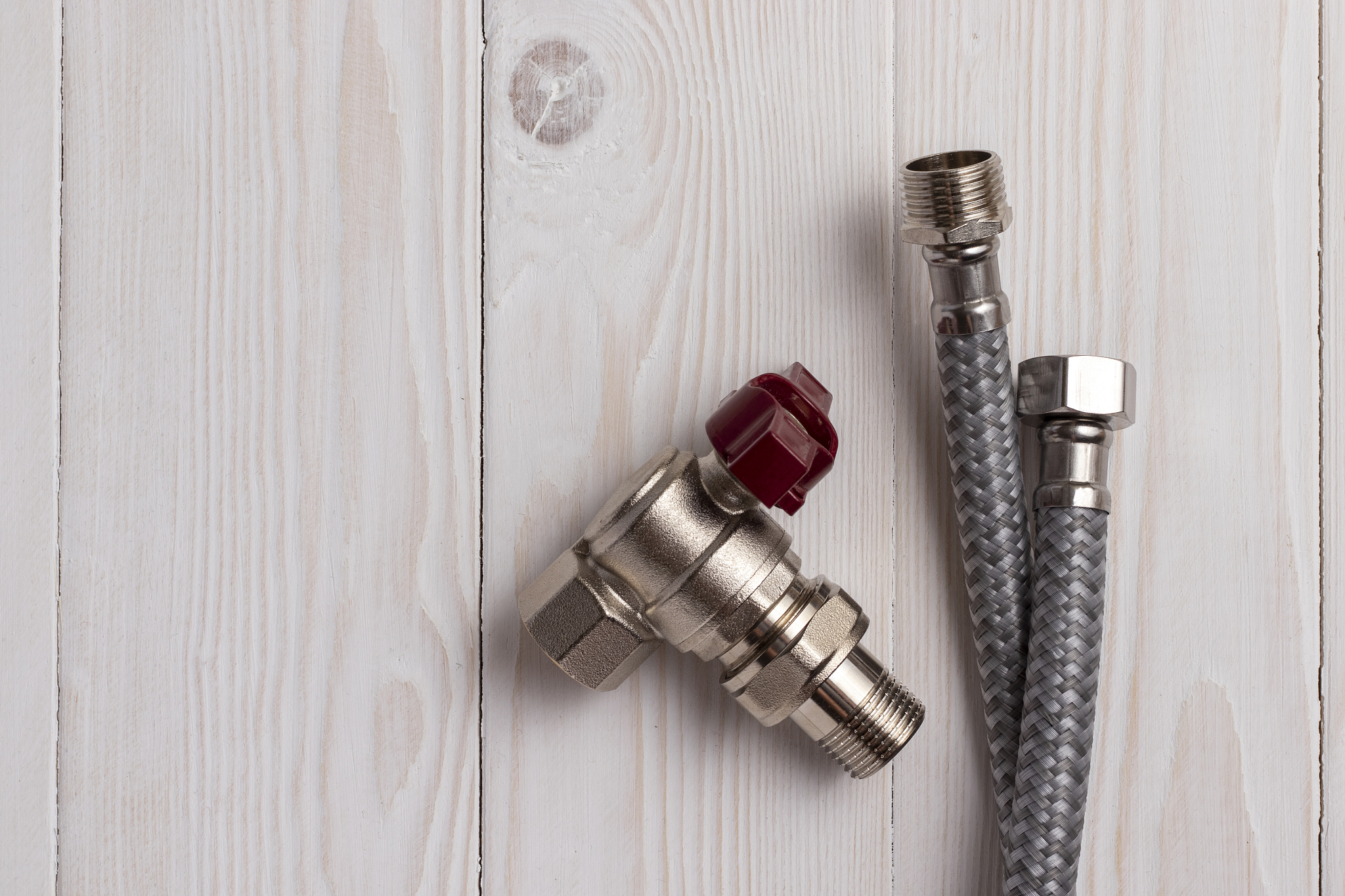 two braided flexible water hoses and an angle water tap.