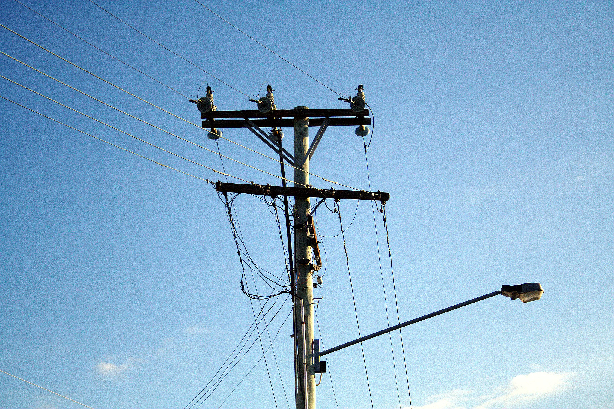 power light pole against a blue sky