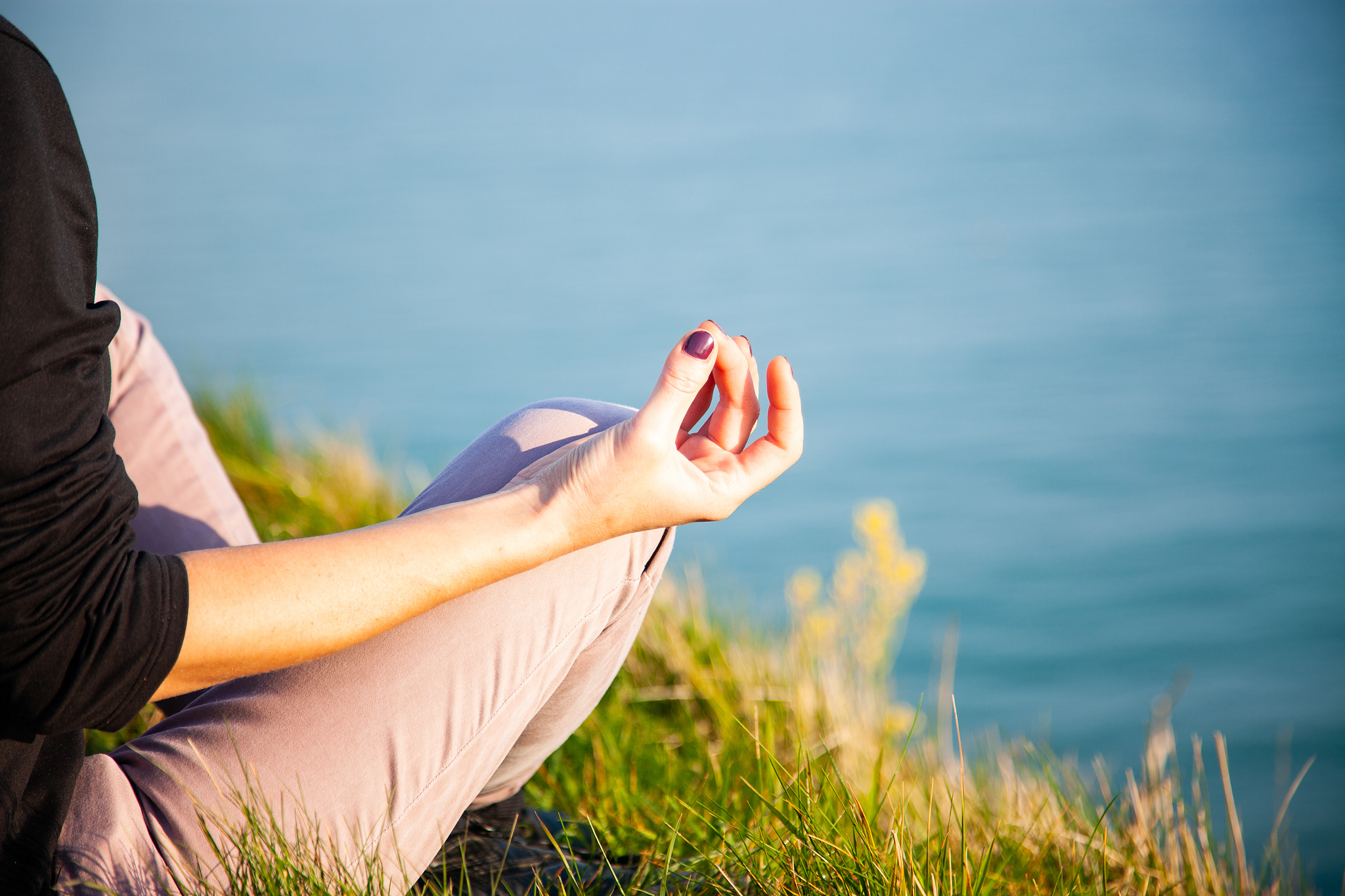 woman doing yoga in beautiful nature background at sunset or sun