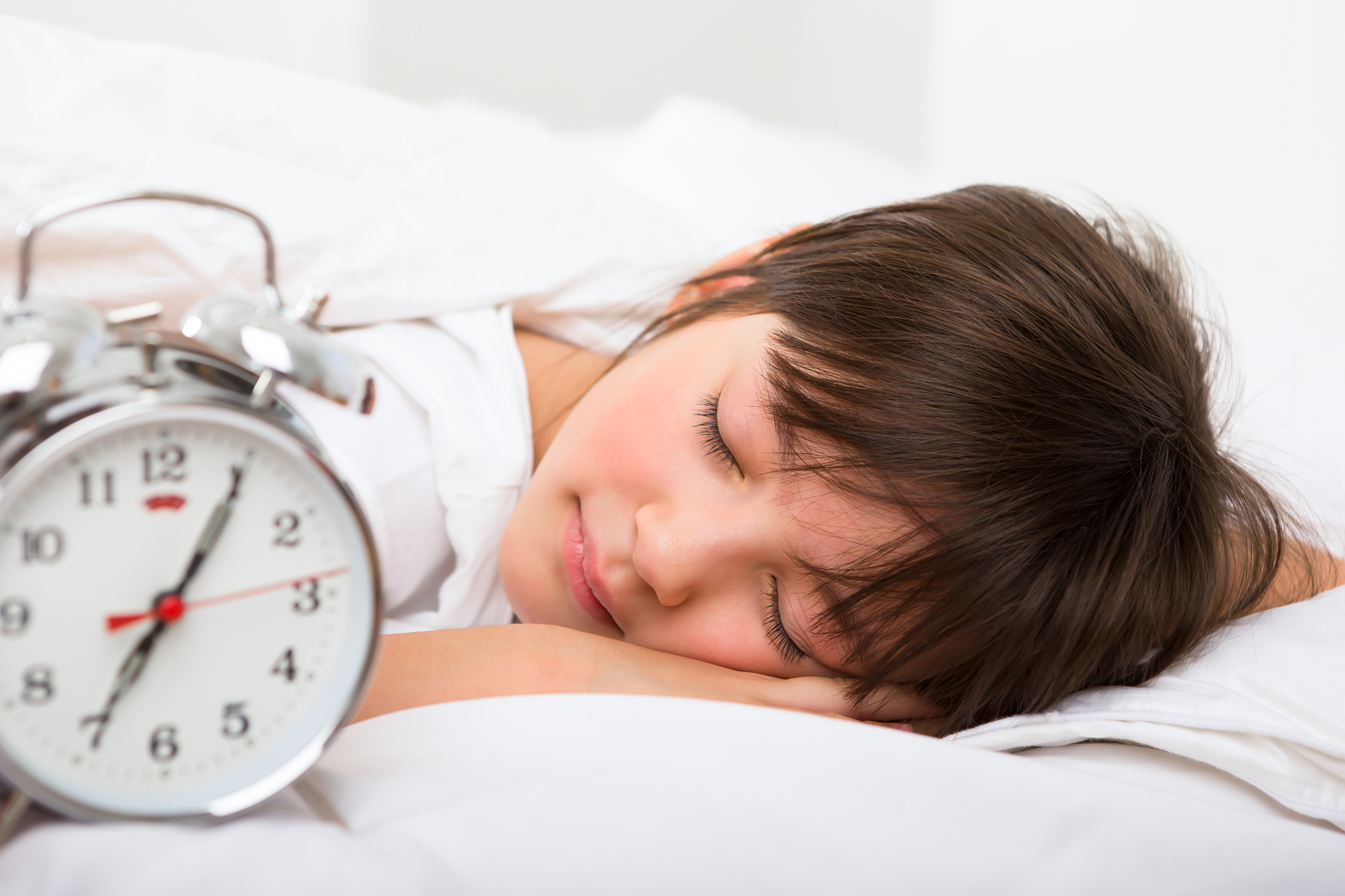 young girl sleeping in bed