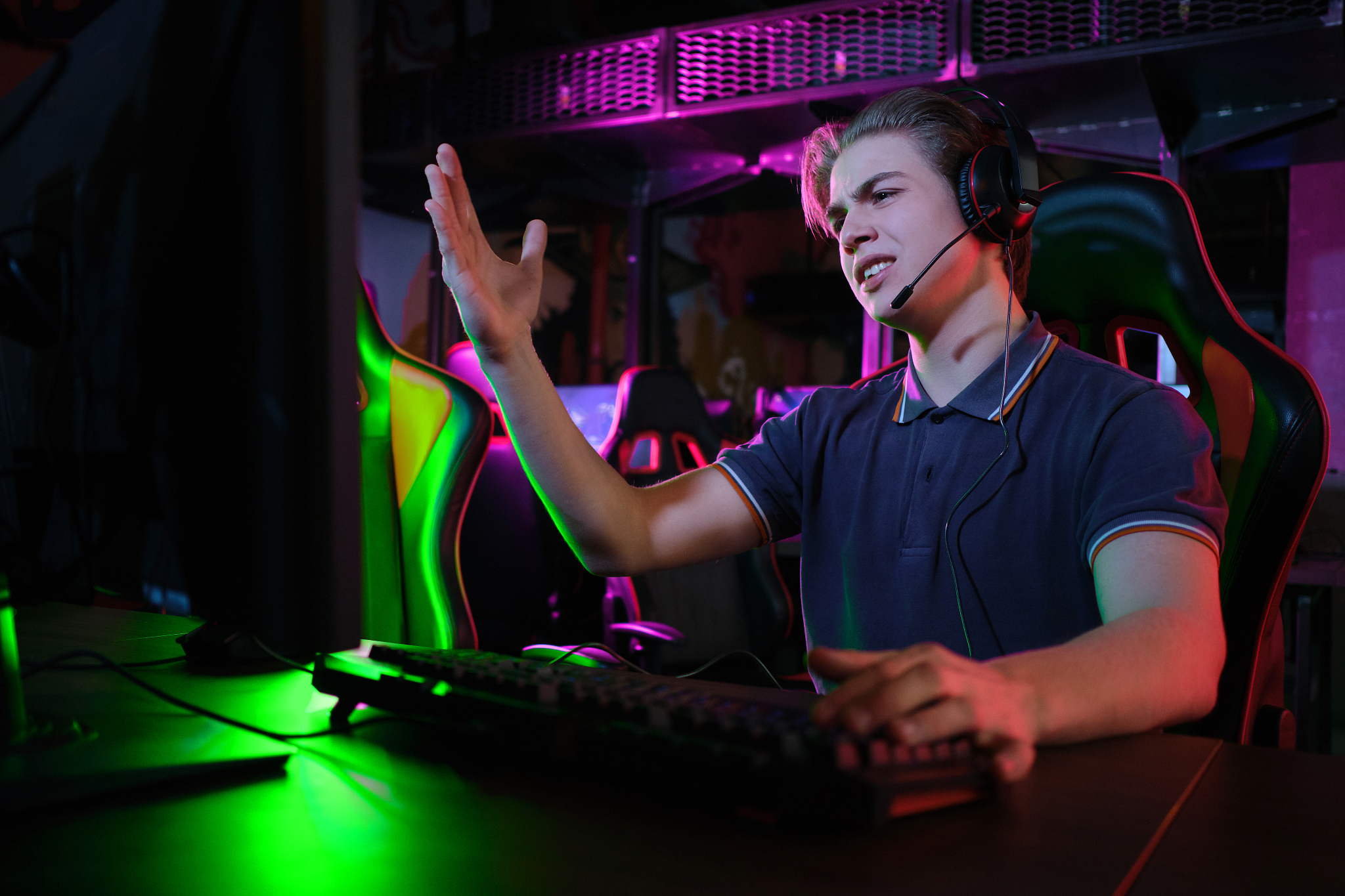 professional young caucasian gamer playing online on his pc. he 