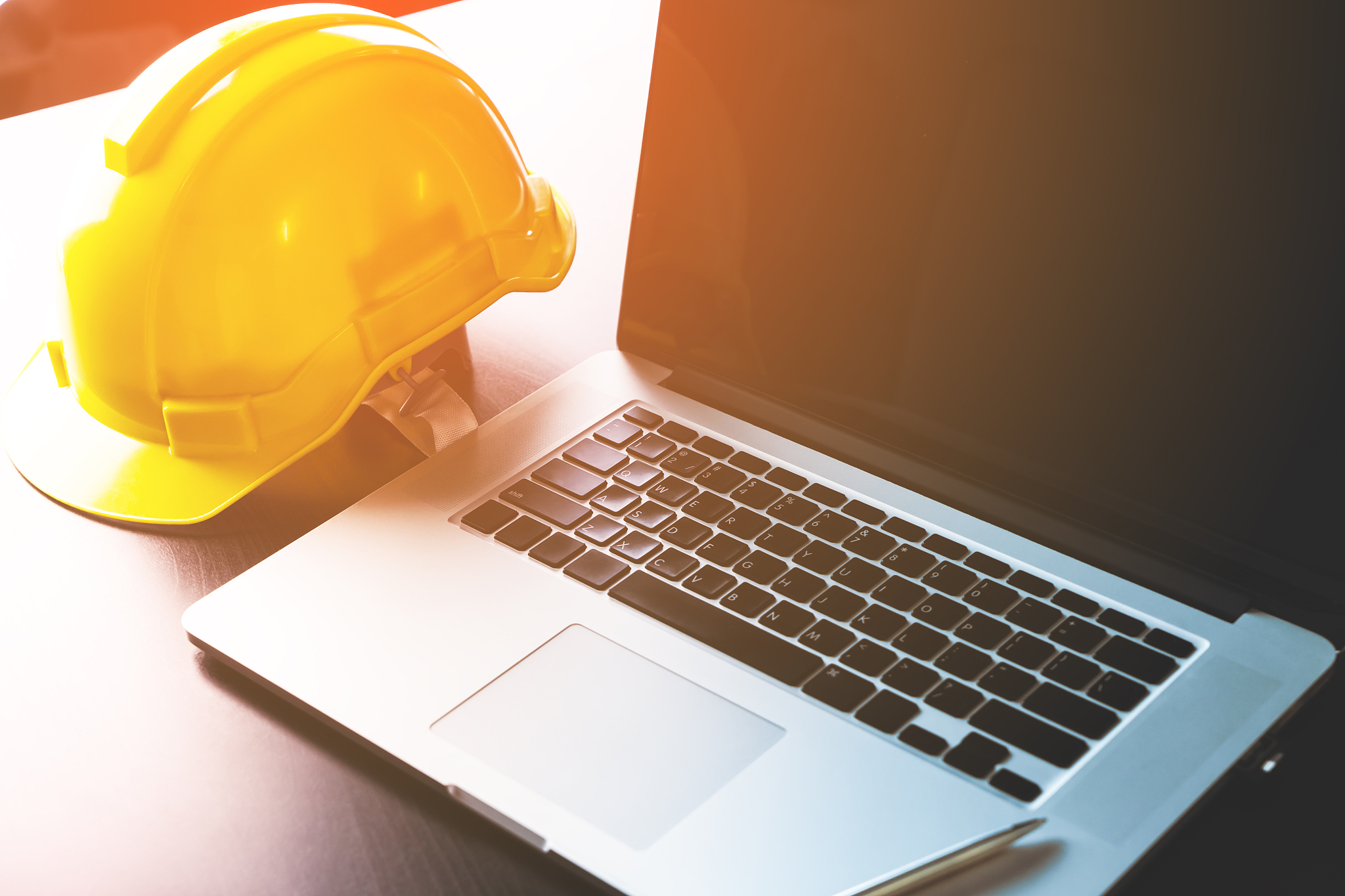 engineer working table with computer and safety helmet