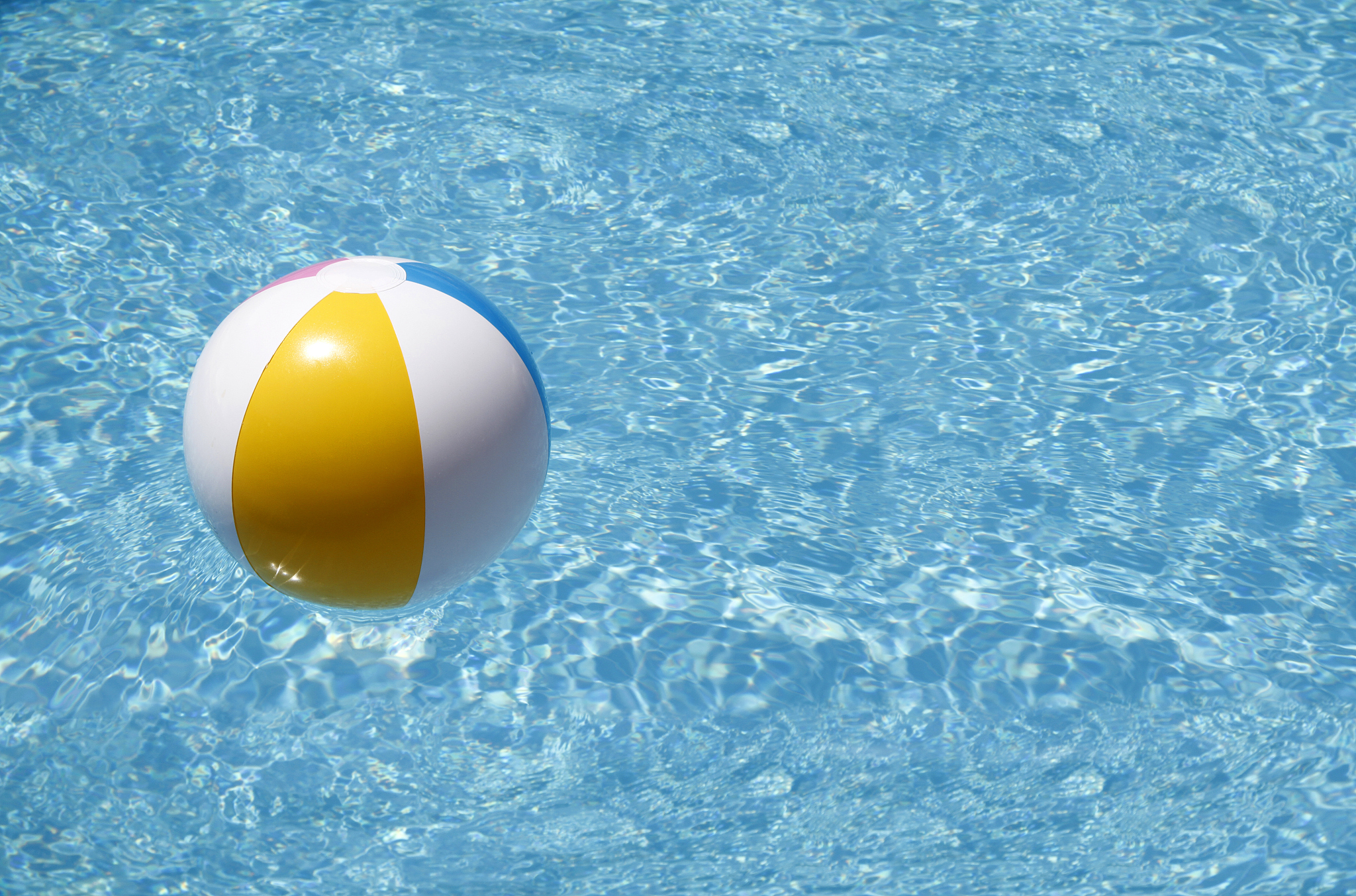 beach ball floating in swimming pool.