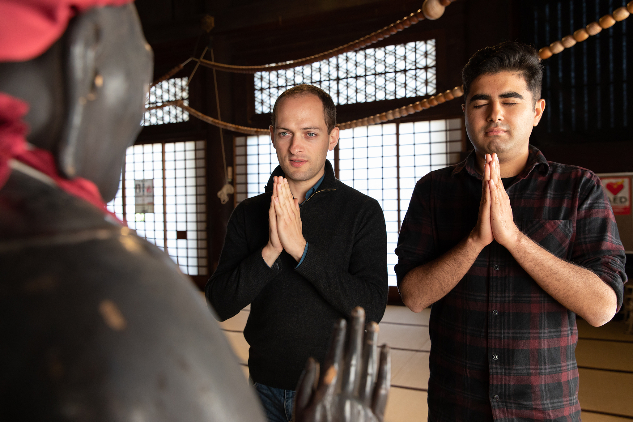 two men praying at temple