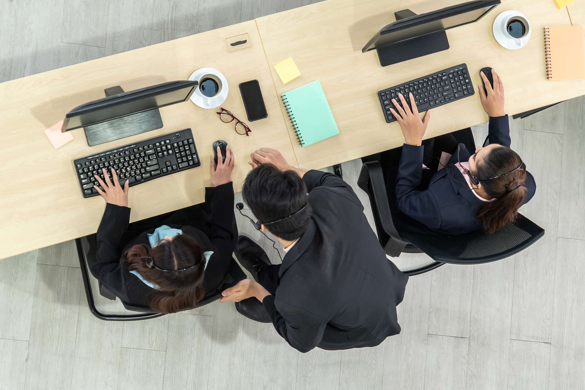 business people wearing headset shot from top view