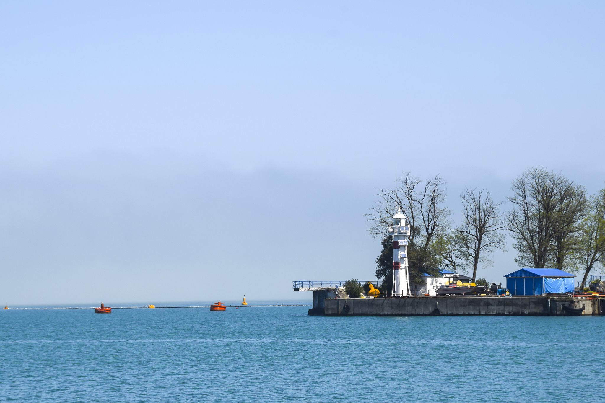 industrial port blue water clear weather white fog on the backgr