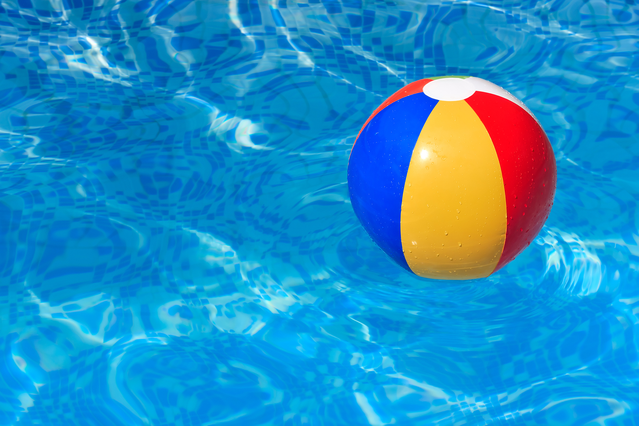 colorful beach ball floating in a swimming pool