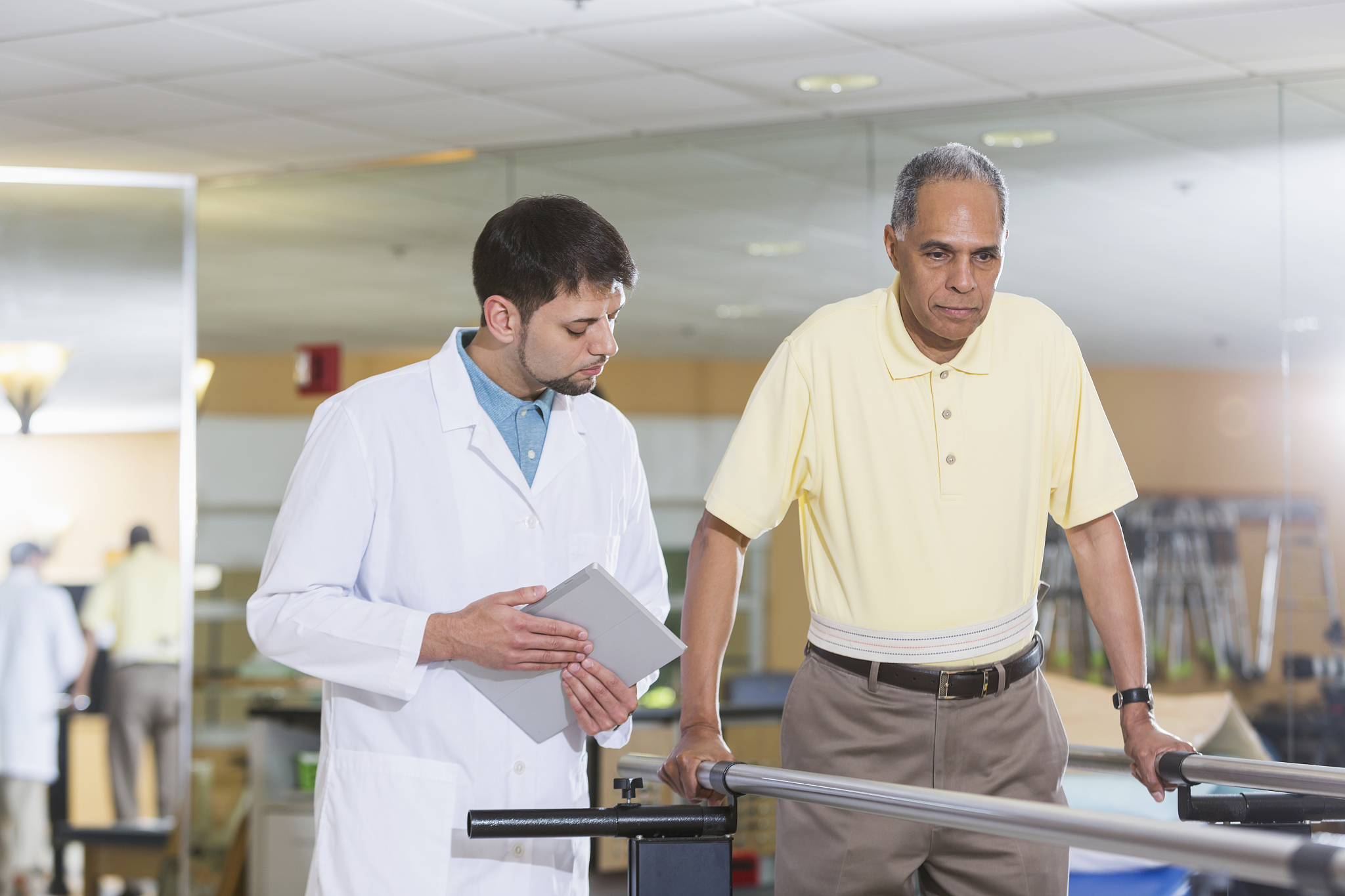 physical therapist working with male patient