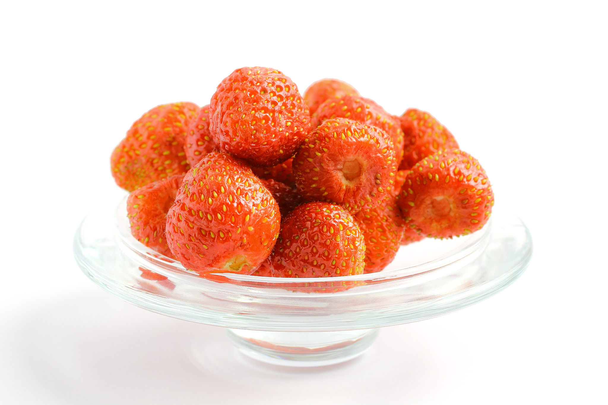 ripe strawberries in a glass vase on a white background. place f