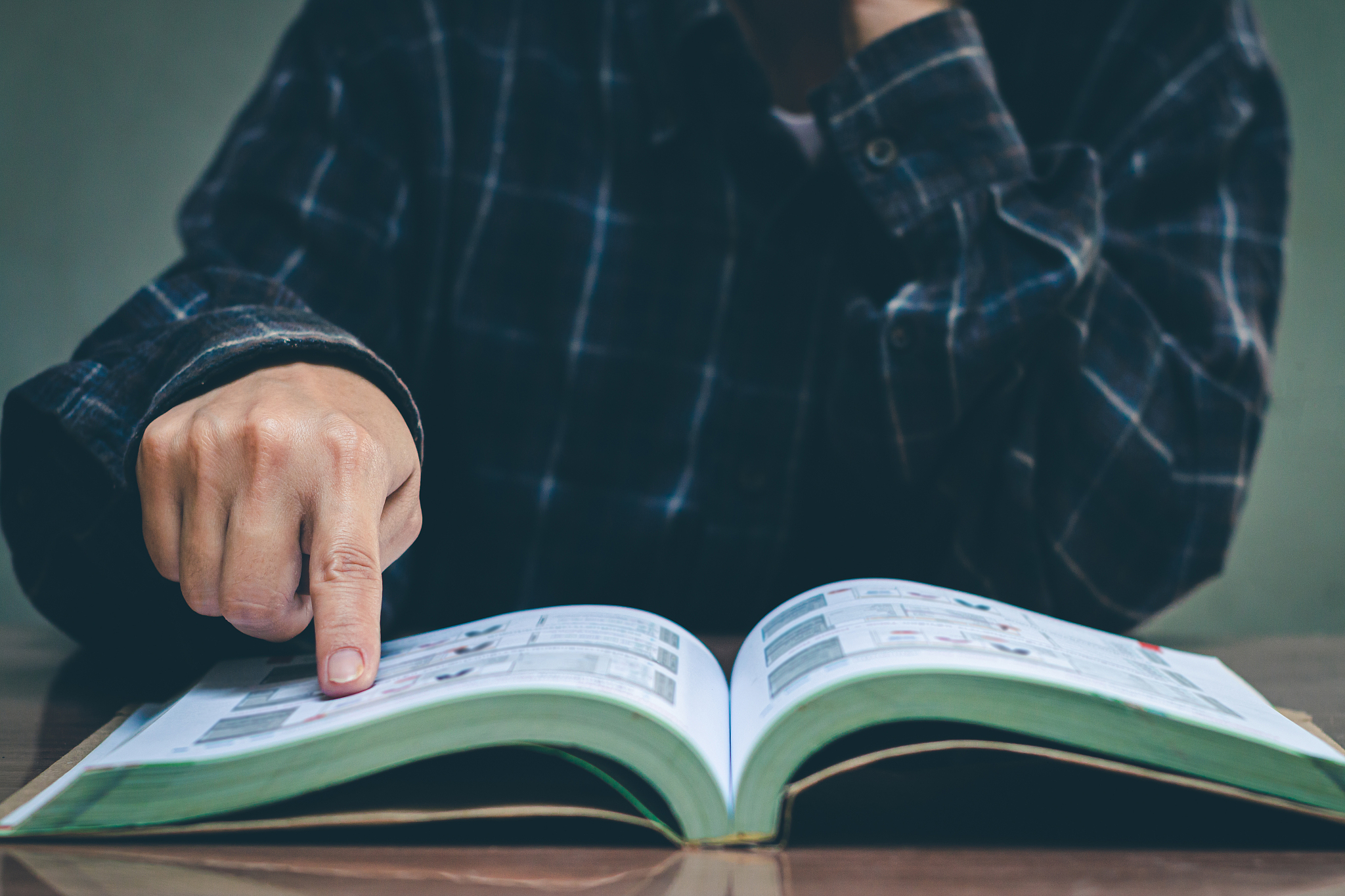 women read holiday book in room quiet environment.