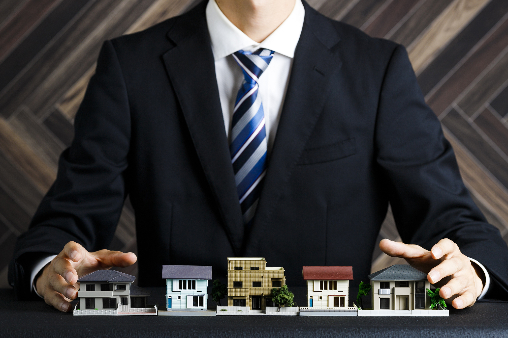 businessman with house model and suit