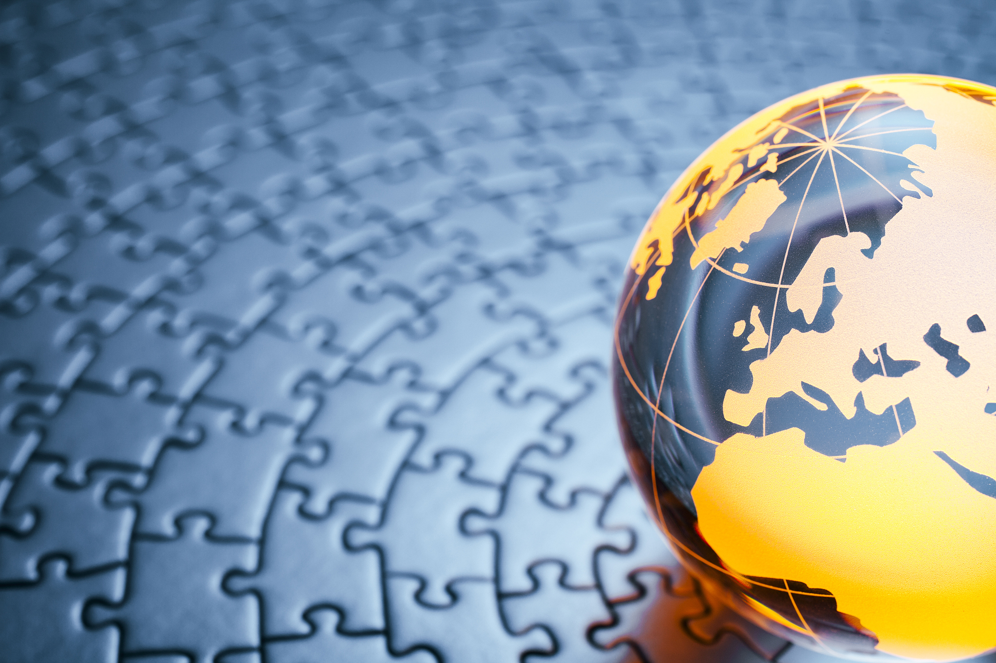 glass globe on circular jigsaw puzzle