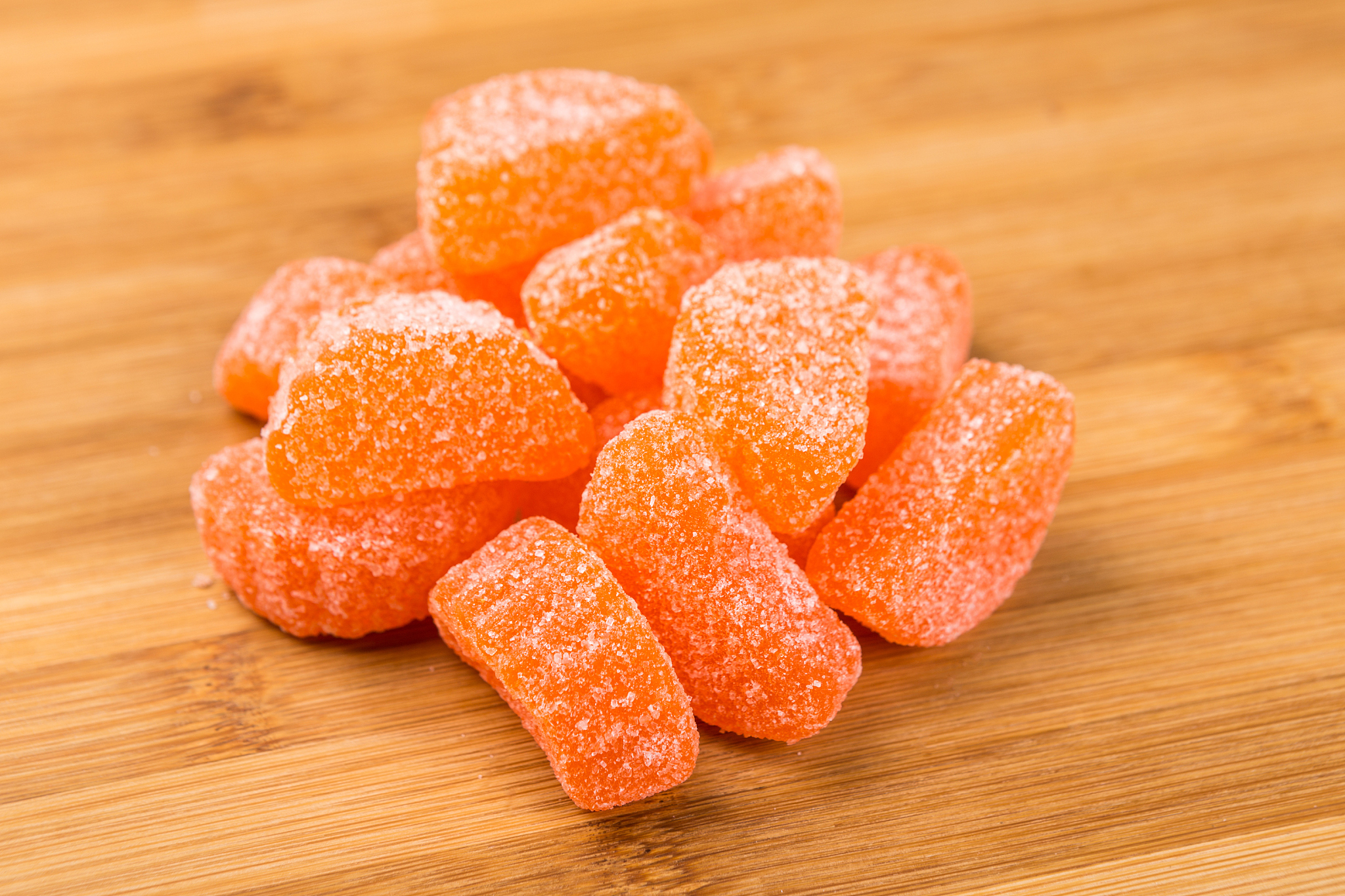orange candy slices isolated on a wood background