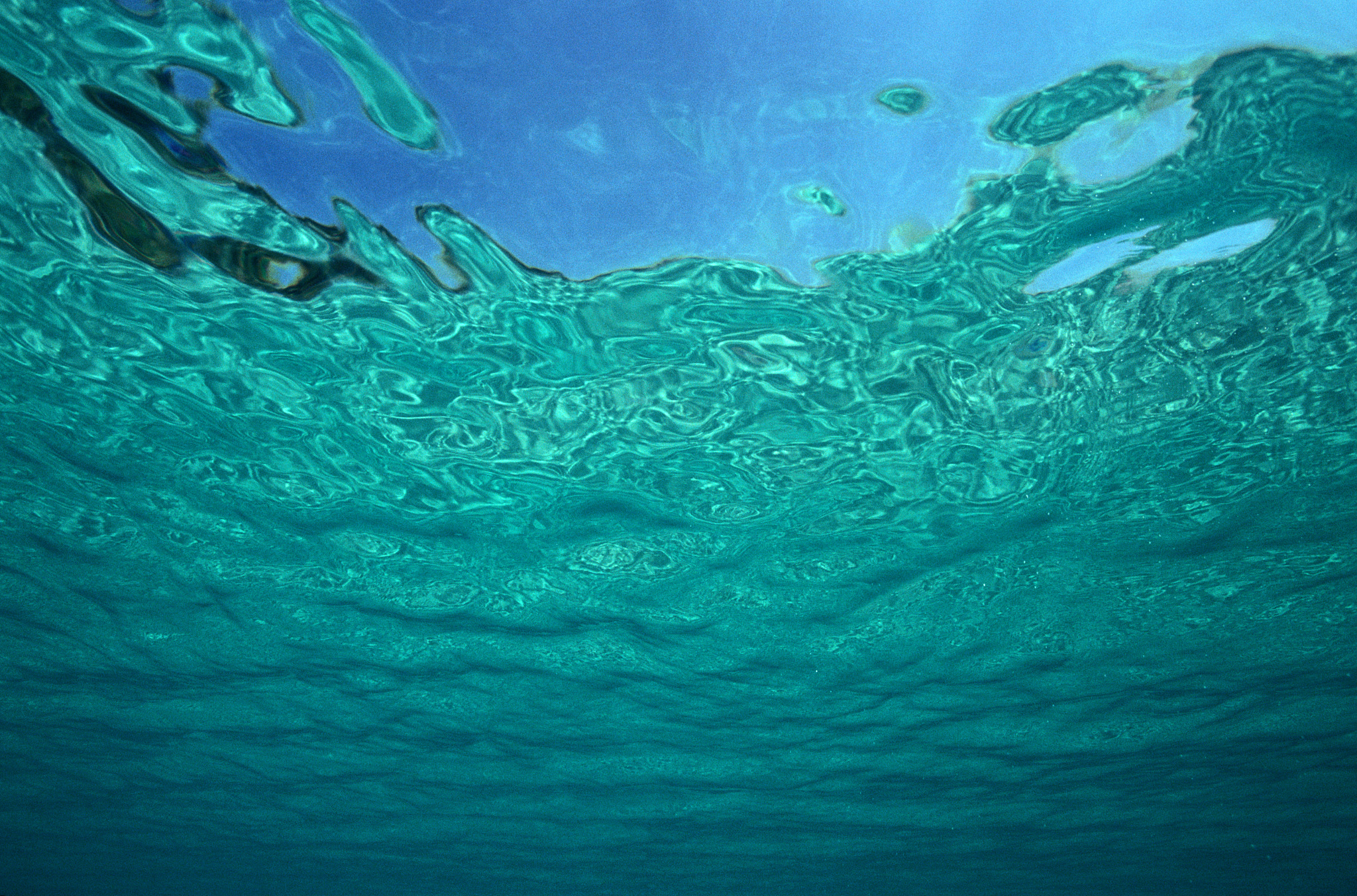 sky viewed through water's surface, underwater view