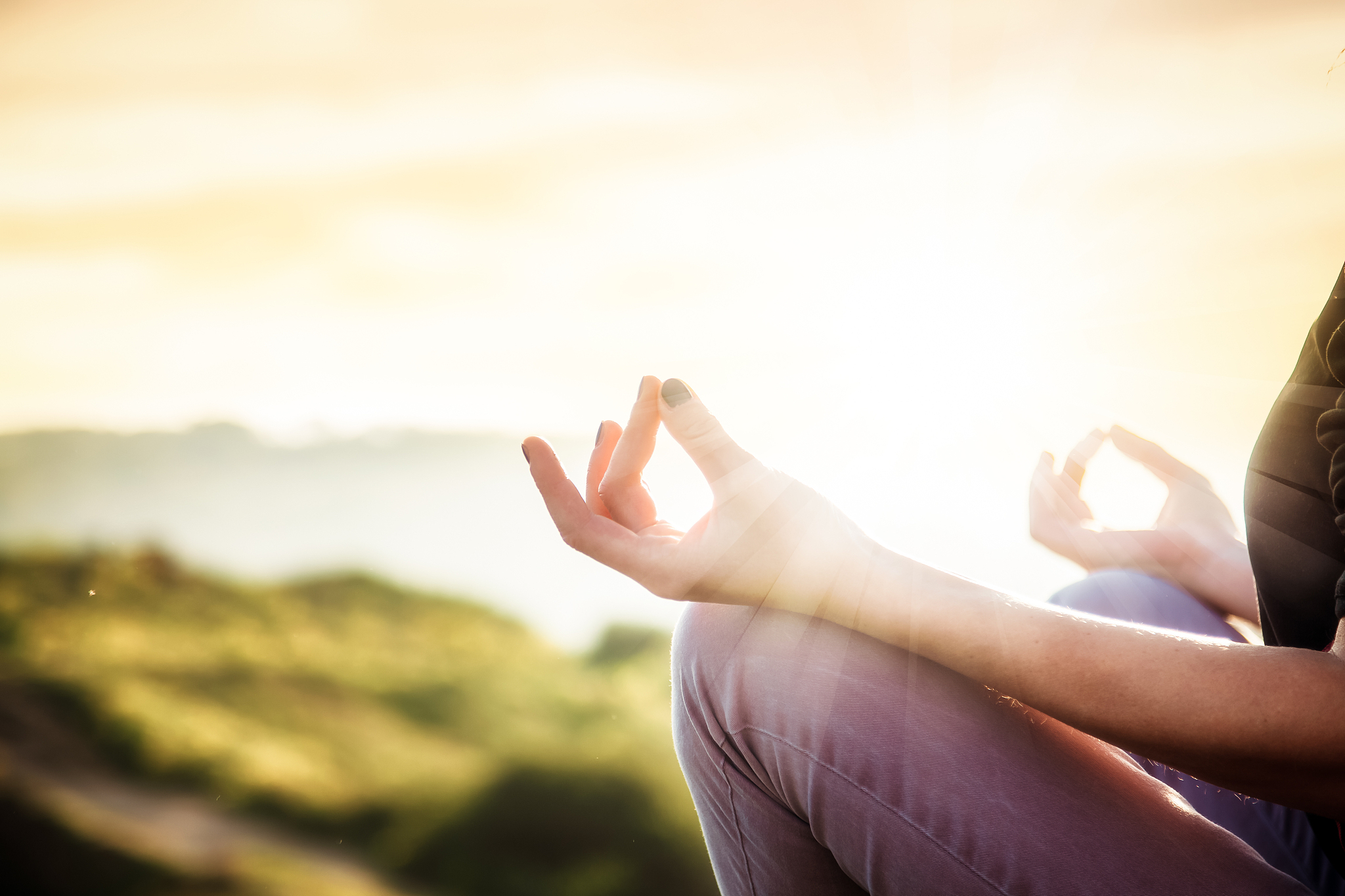 woman doing yoga in beautiful nature background at sunset or sun