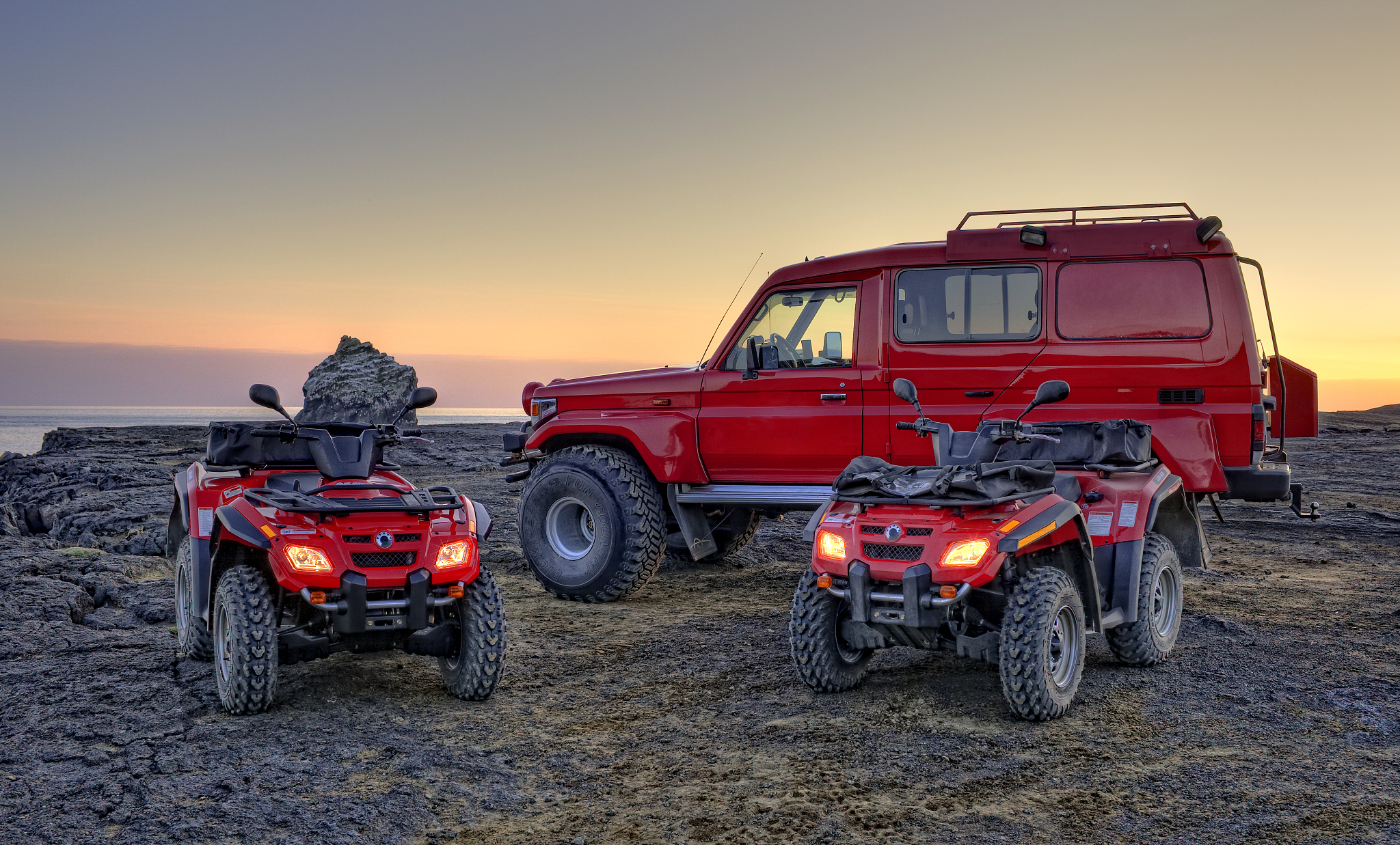 four-wheelers and suv on lava rock