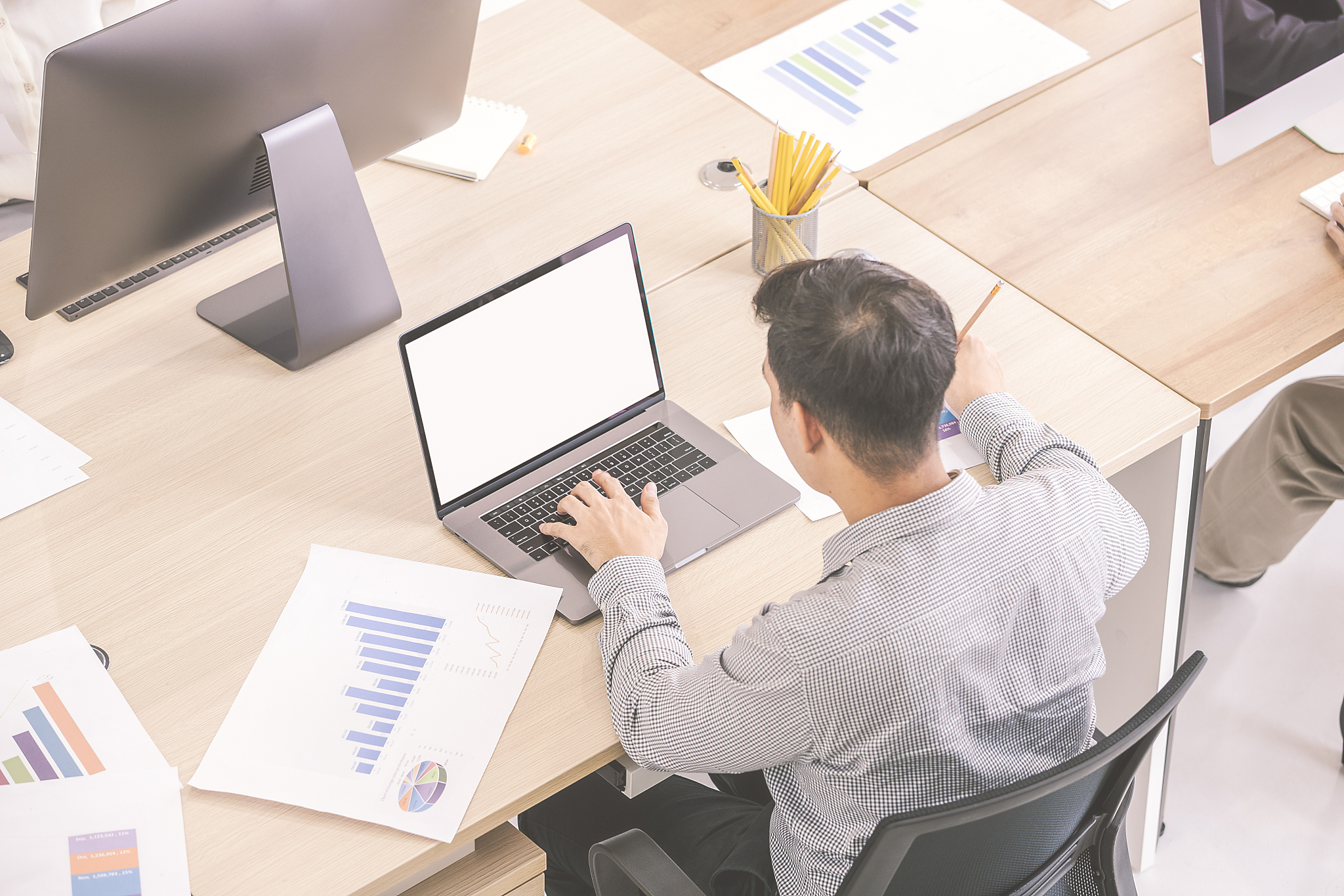 man working on computer in office.