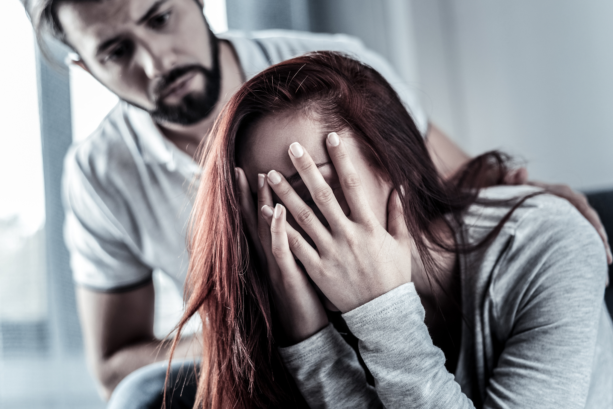 frustrated upset woman sitting and hiding face behind hands