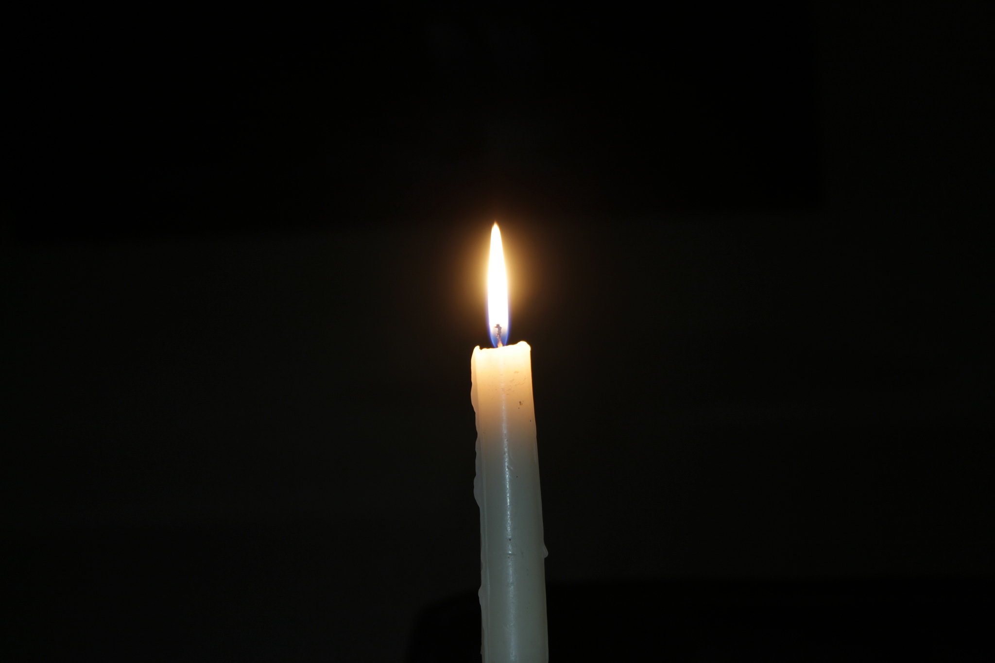 close-up of lit candle in the dark