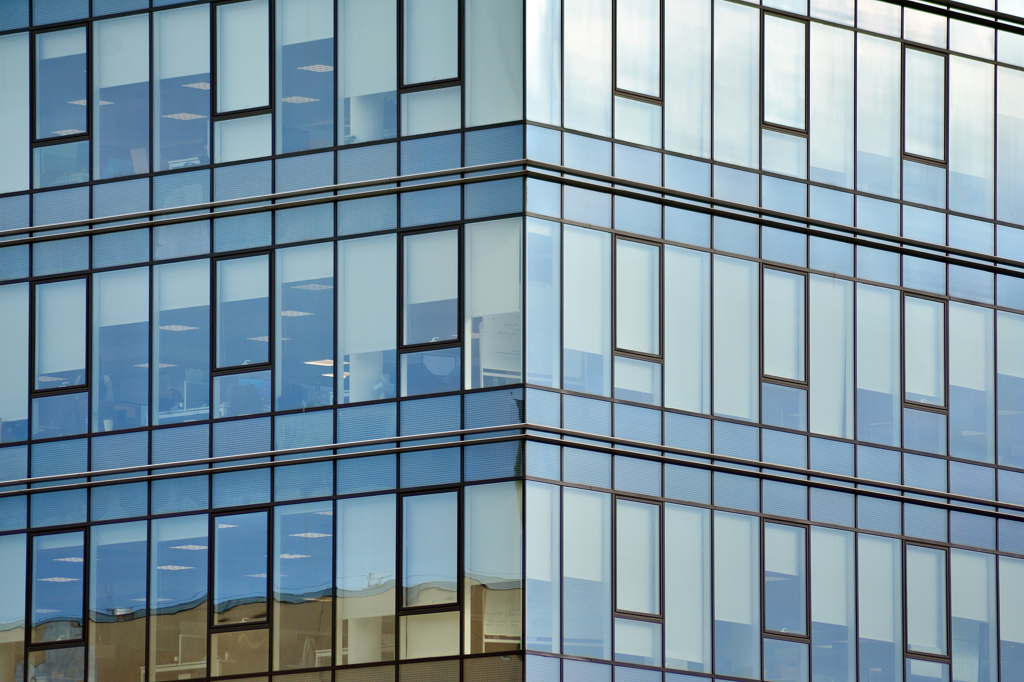 modern building with reflected sky and cloud in glass window