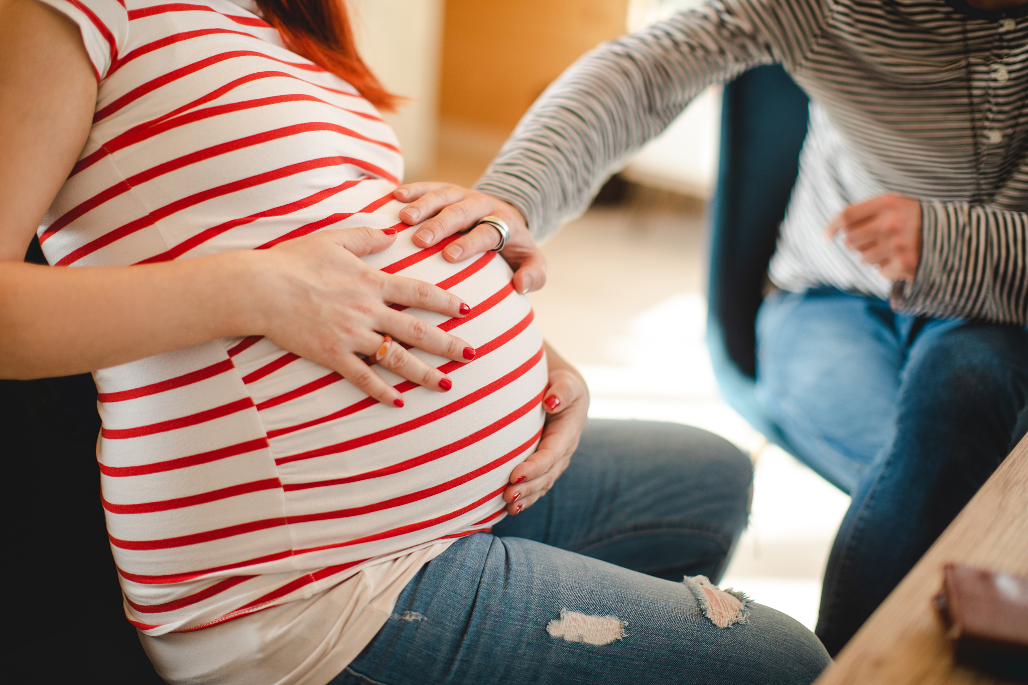 excited future father cuddle his wife's pregnant belly