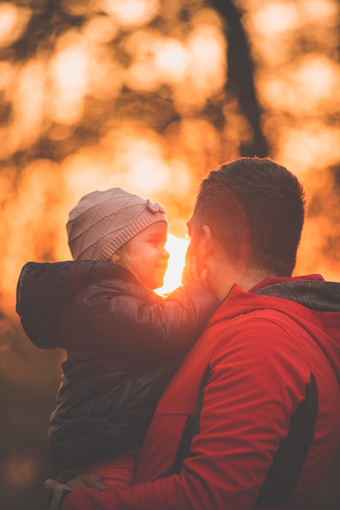daughter and her father at sunset