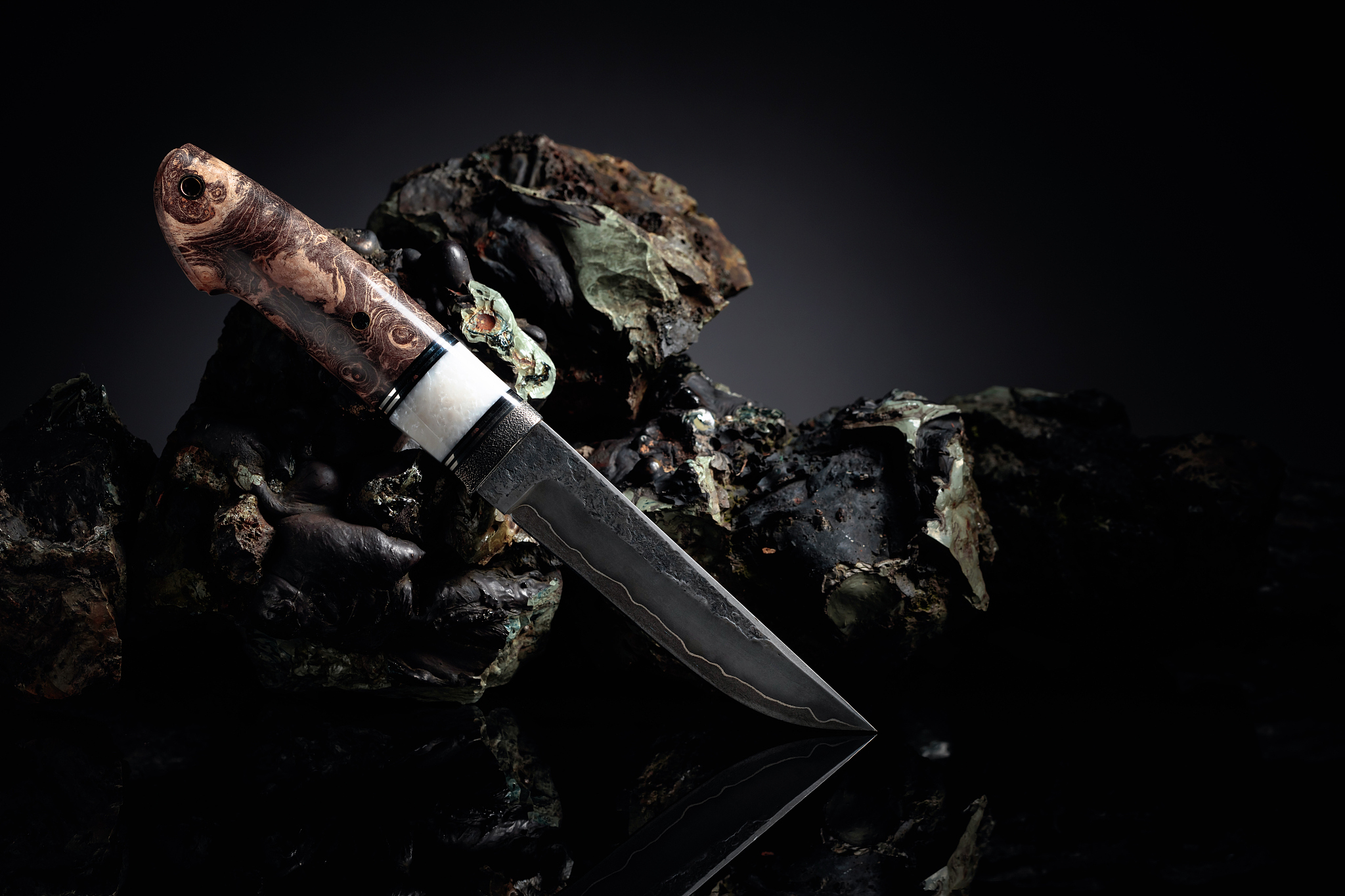hunter combat hand made knife and broken stones.