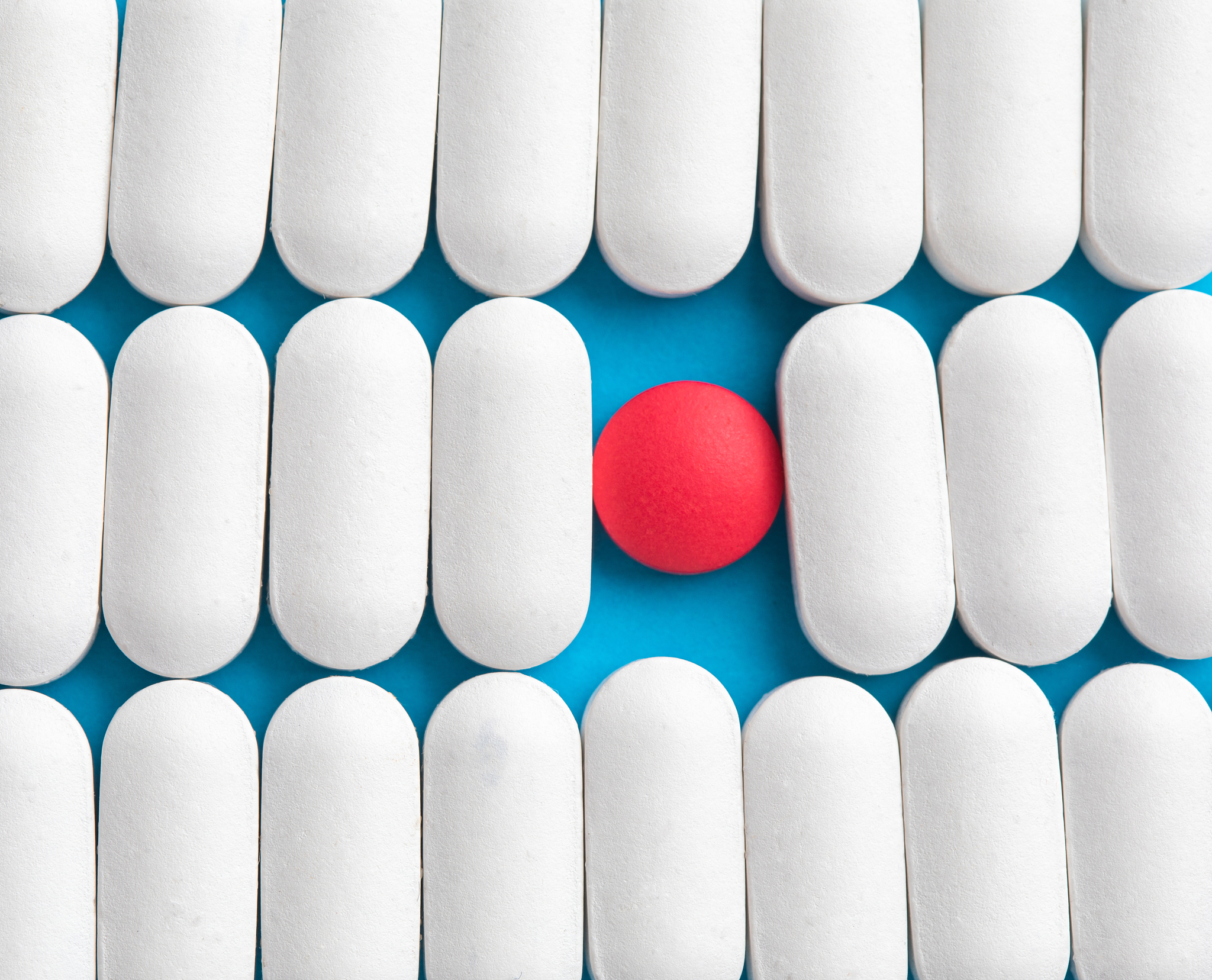 one red pill among white pills. concept of uniqueness