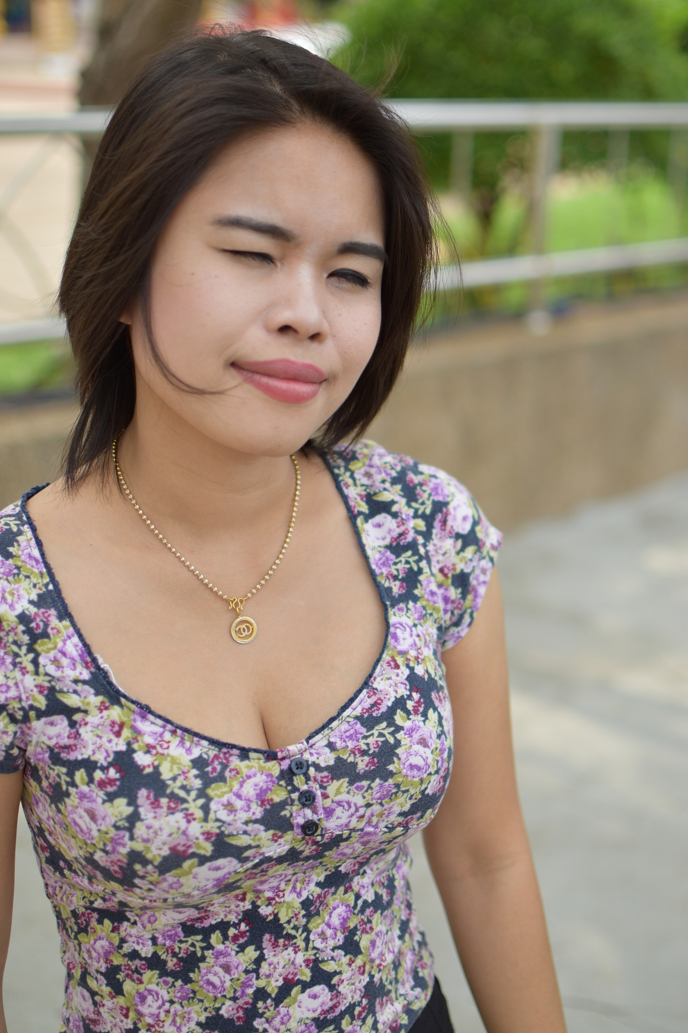 smiling young woman with short hair looking away while standing 