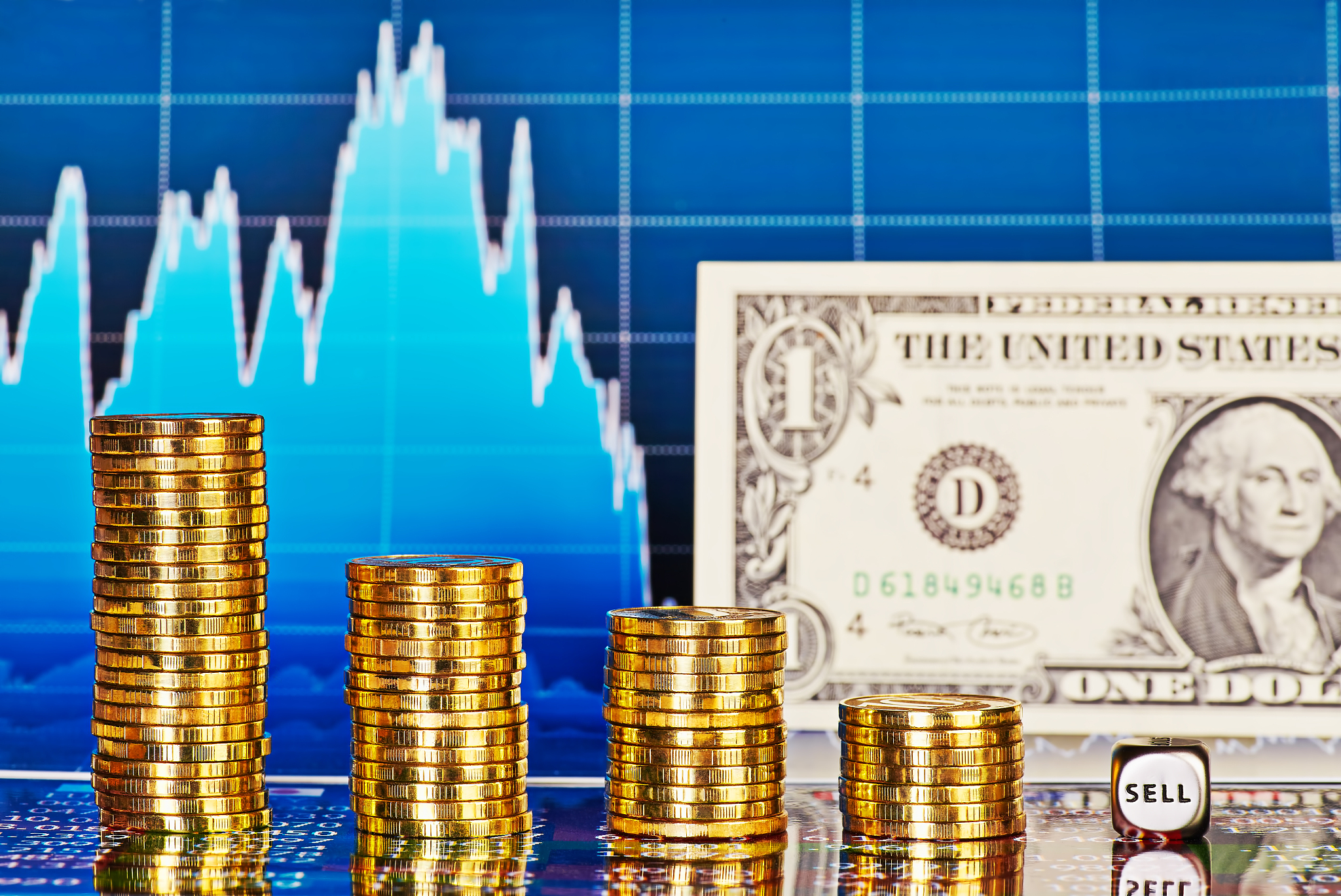 downtrend chart, one-dollar banknote, golden coins, dices cube