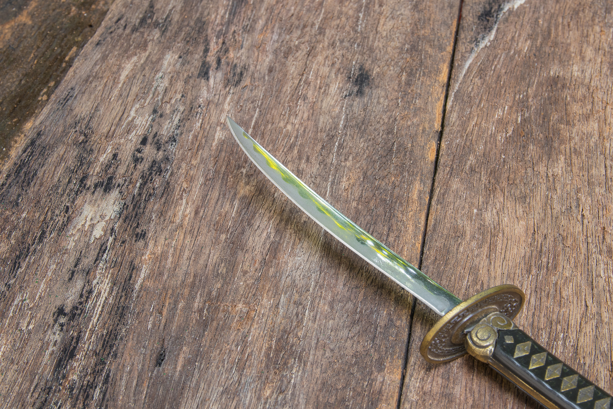 sword steel blade samurai pierce on old wooden surface floor wit