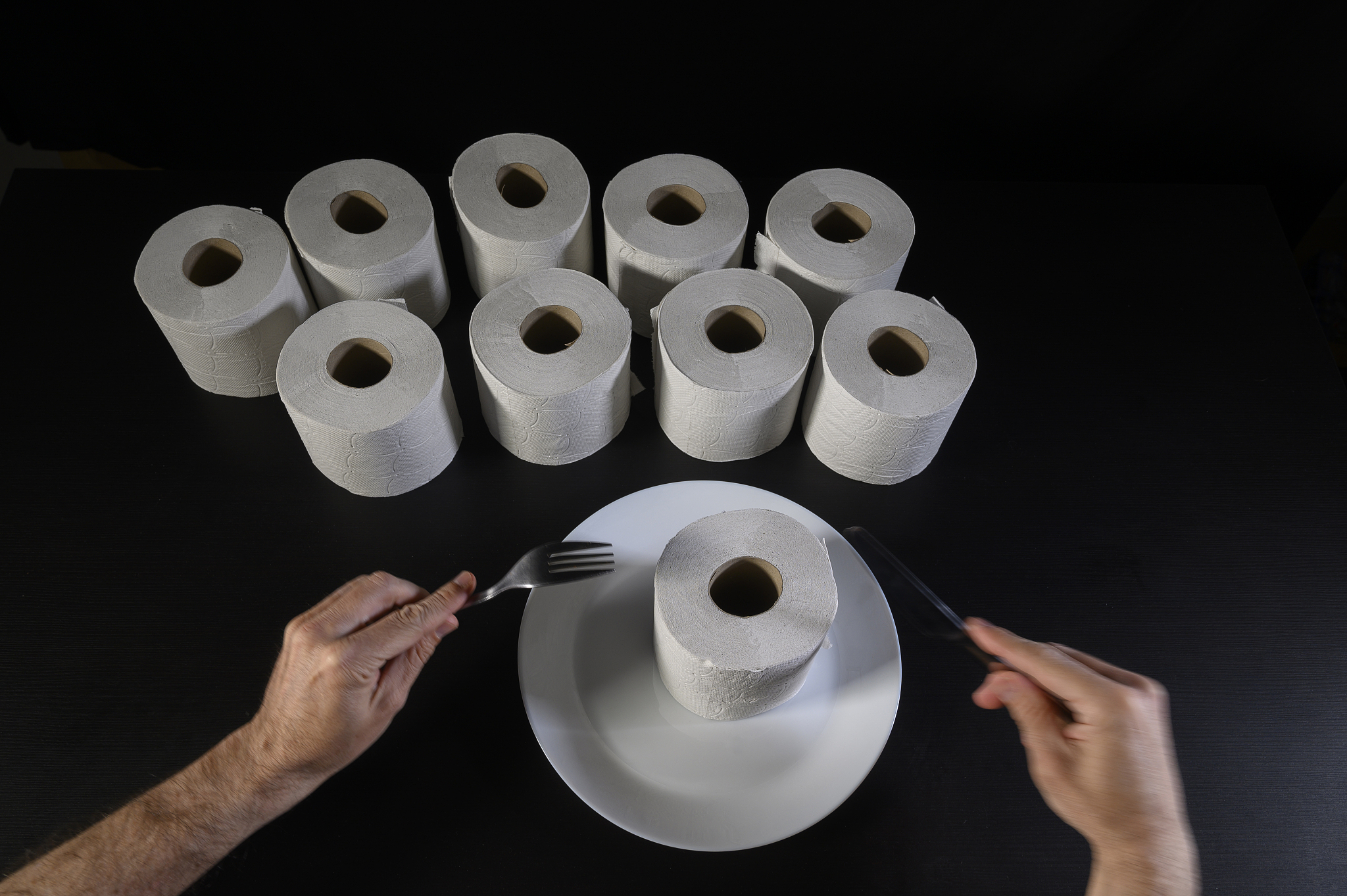humor. a man is having for dinner a roll paper!