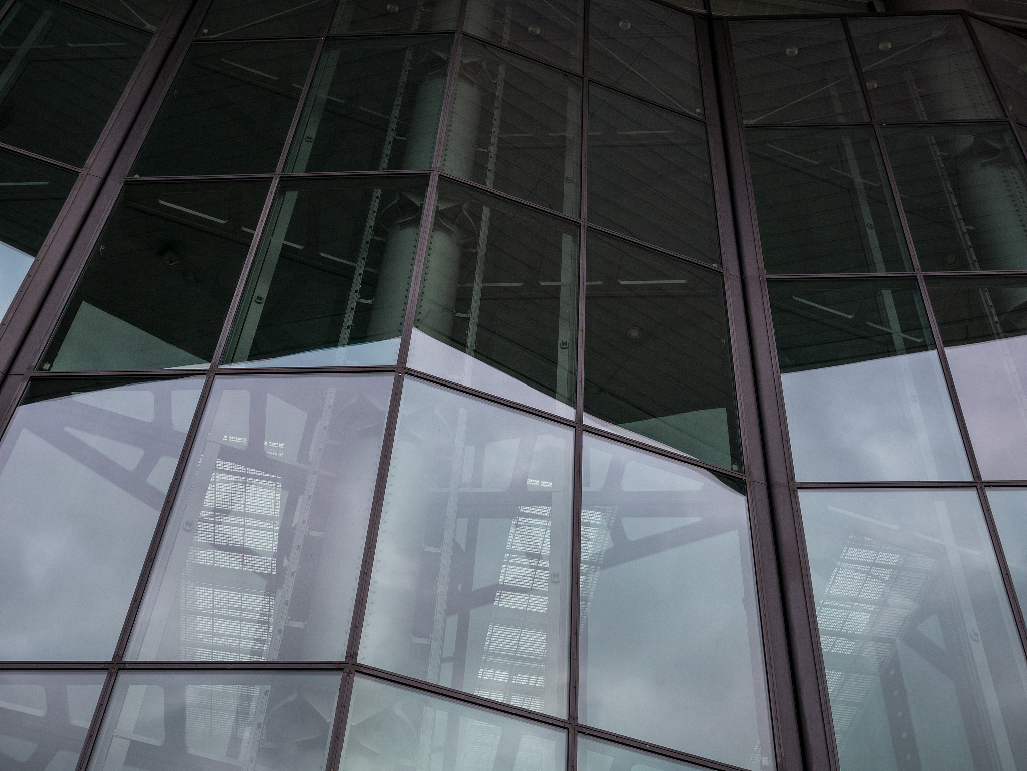the glass architecture in city against a sky