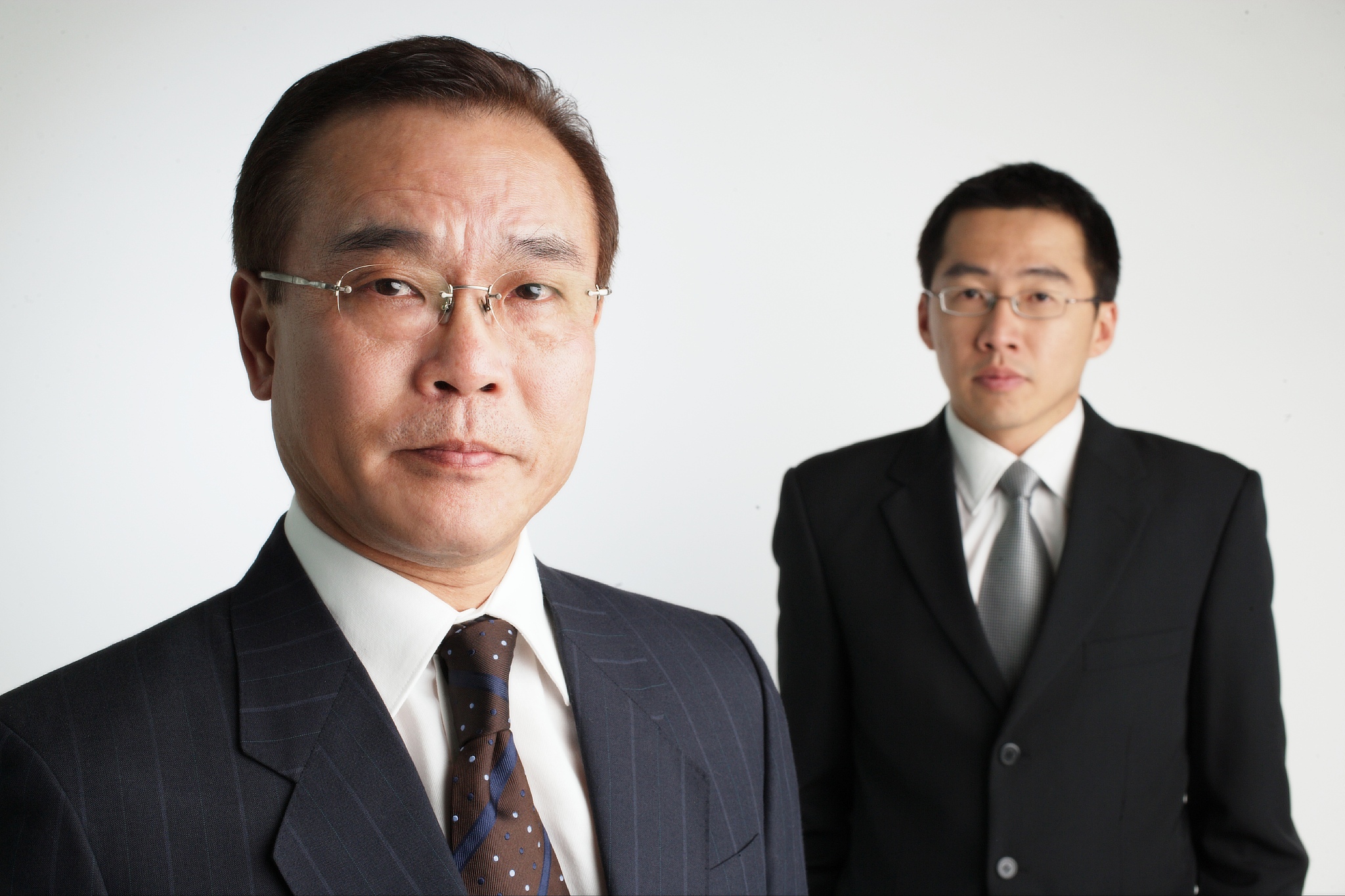 two businessmen looking at camera