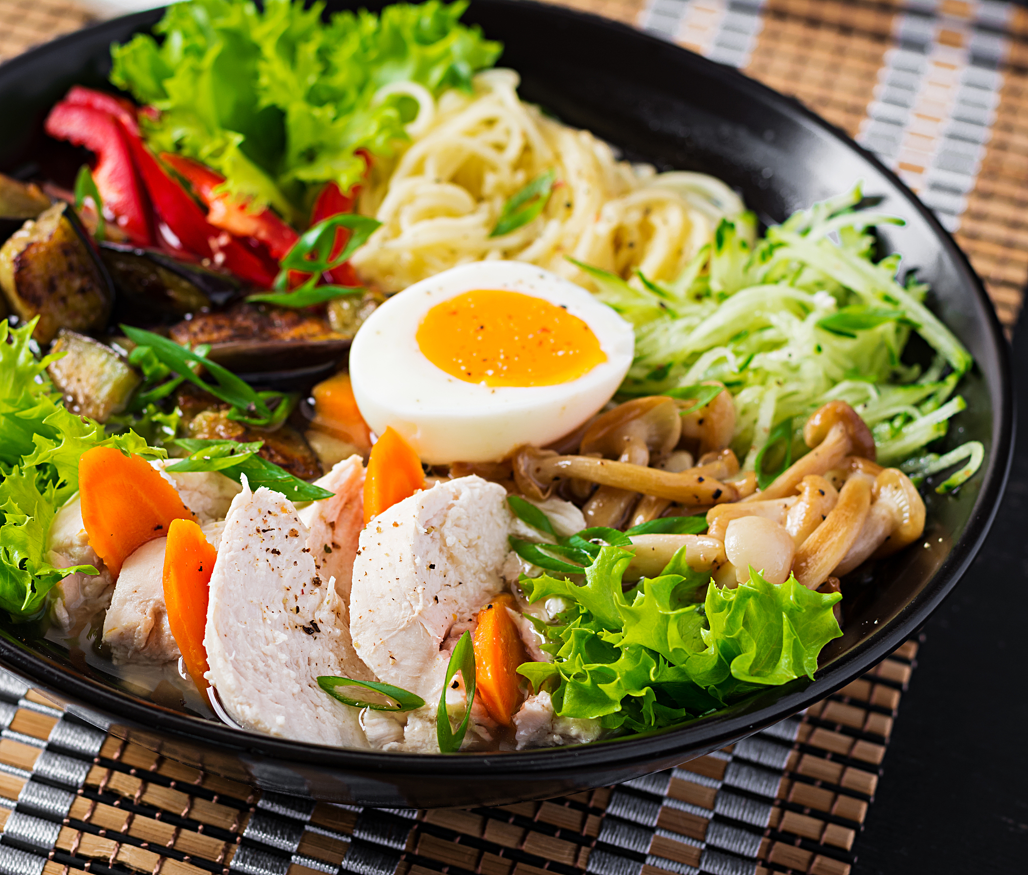 japanese ramen soup with chicken, egg, shimeji mushrooms and egg